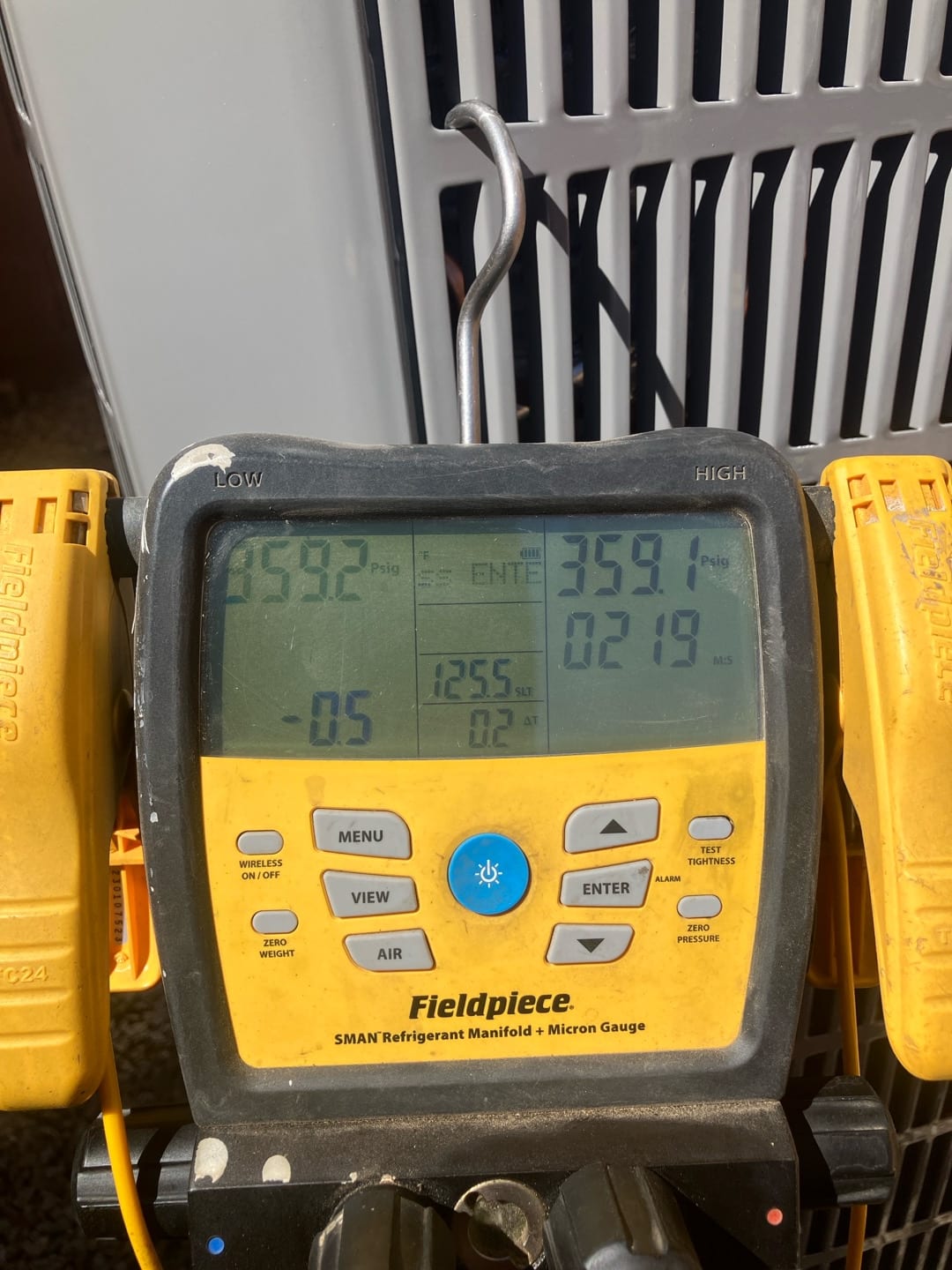 Digital manifold gauges show equal pressures near 359 PSI on both sides during a nitrogen pressure test of the new system.