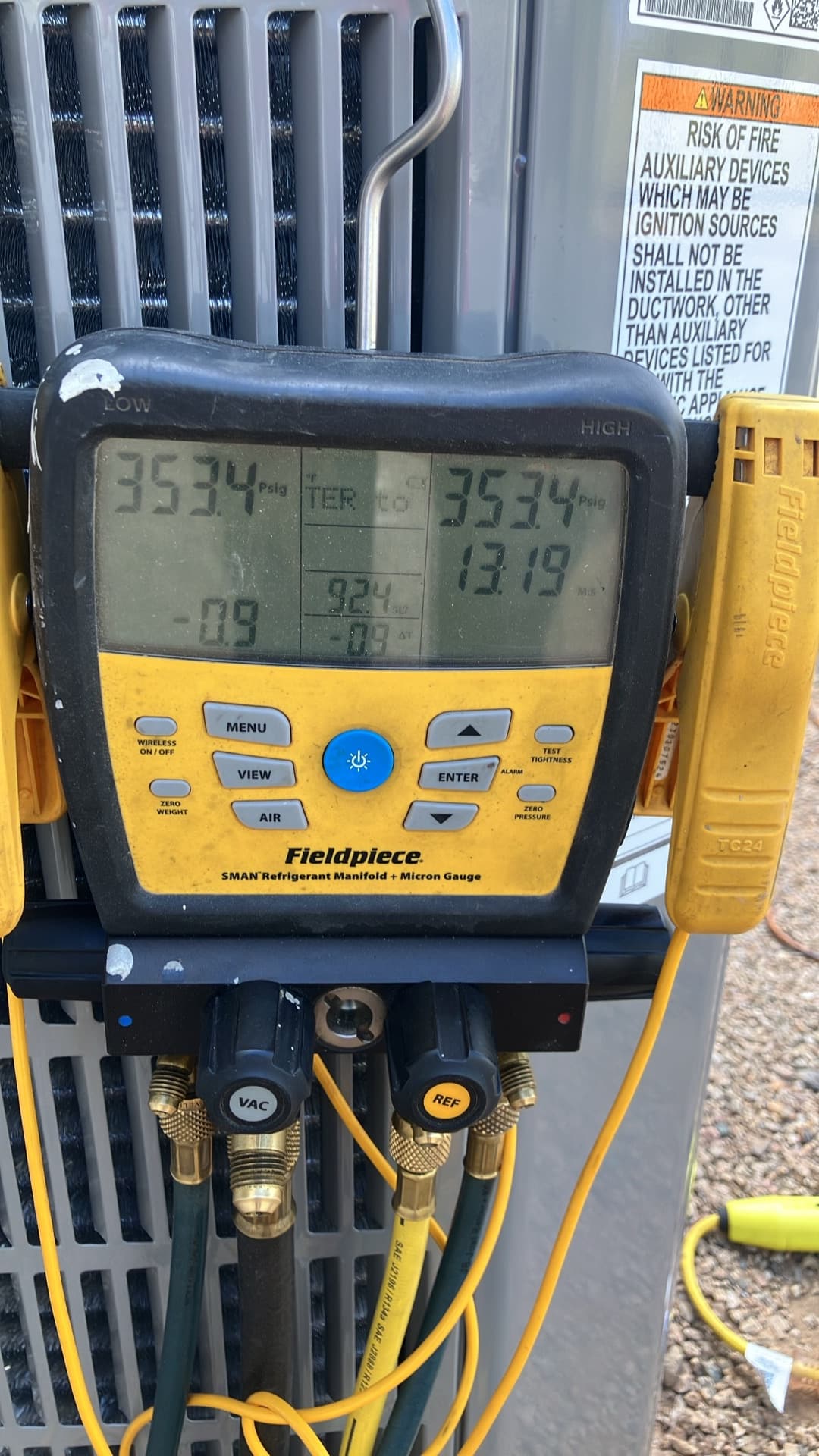 Digital manifold shows both high and low sides holding 353 PSI during a nitrogen pressure test on the new installation.