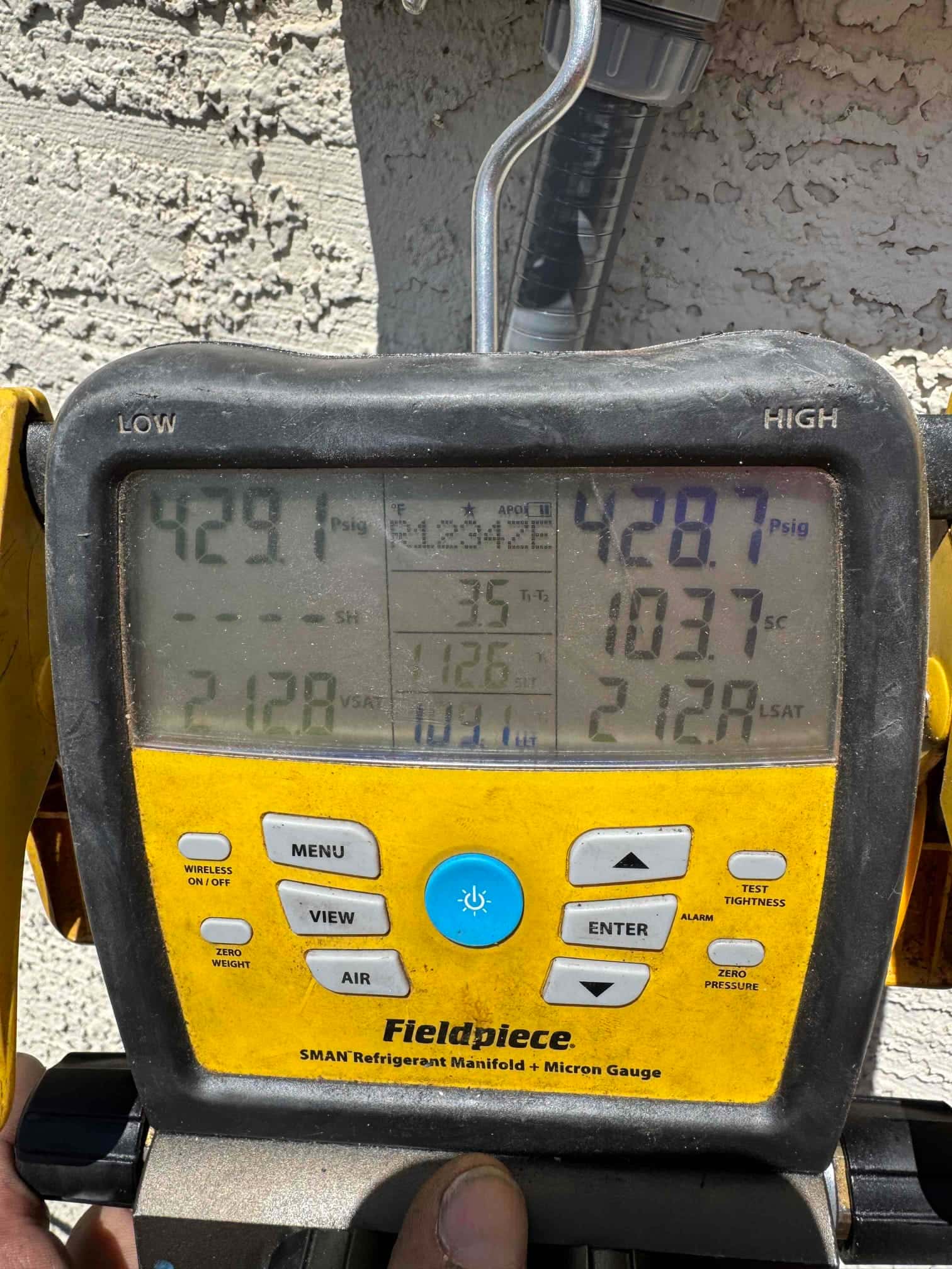Digital manifold shows both high and low sides holding around 429 PSI during a nitrogen pressure test on the new installation.