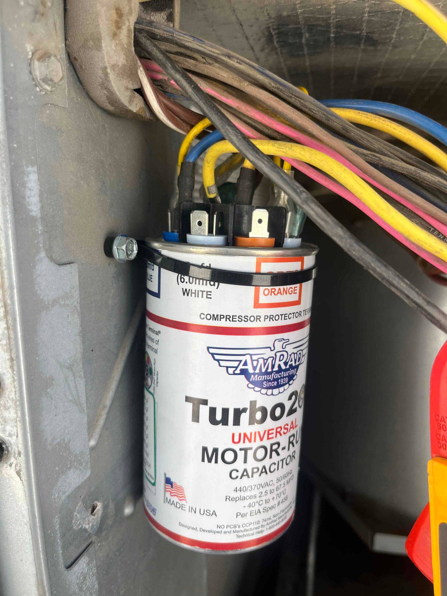 Dual-run capacitor installed in the condenser, labeled 45/7.5 μF with color-coded terminals and connected fan and compressor wires.