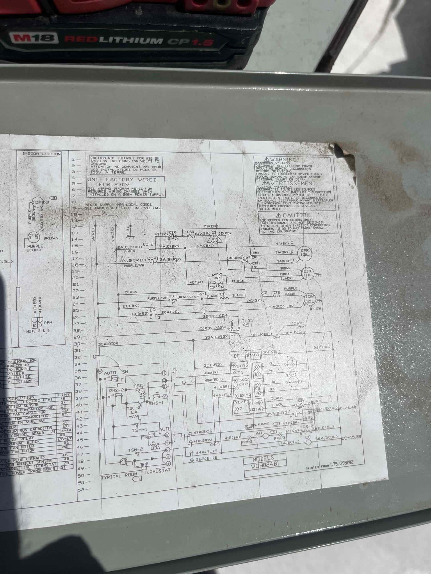 Electrical schematic inside an HVAC unit service panel, showing wiring diagram and component connections used for diagnostics.