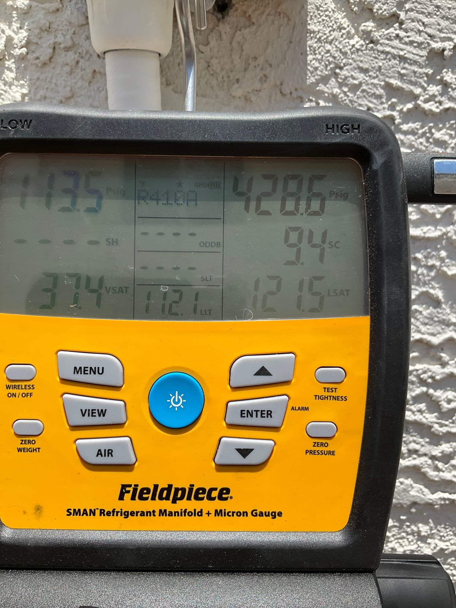 HVAC diagnostic instrument photographed during the service visit.
