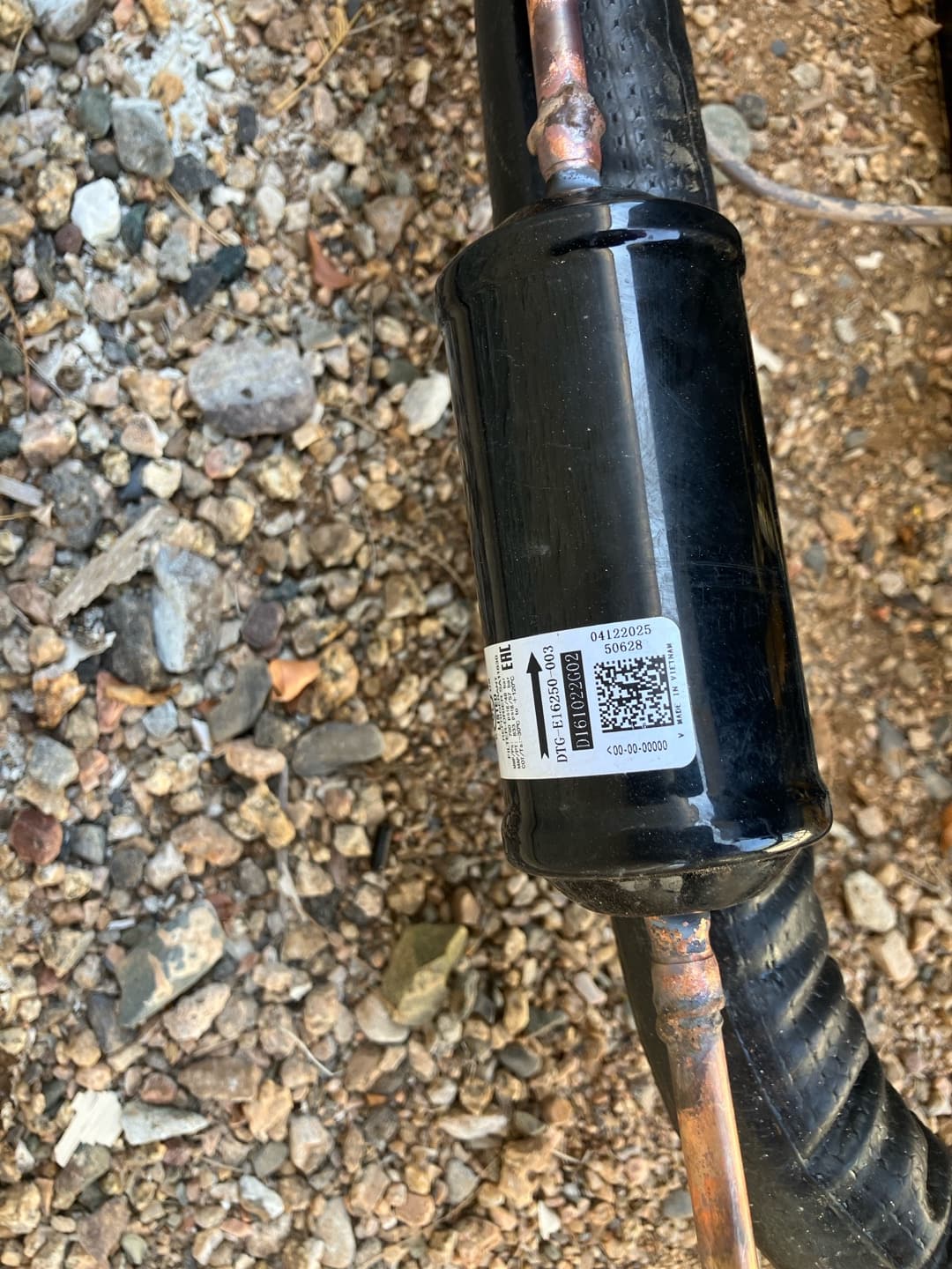 Liquid line filter-drier brazed into the copper refrigerant line with insulated suction line alongside at the outdoor unit.