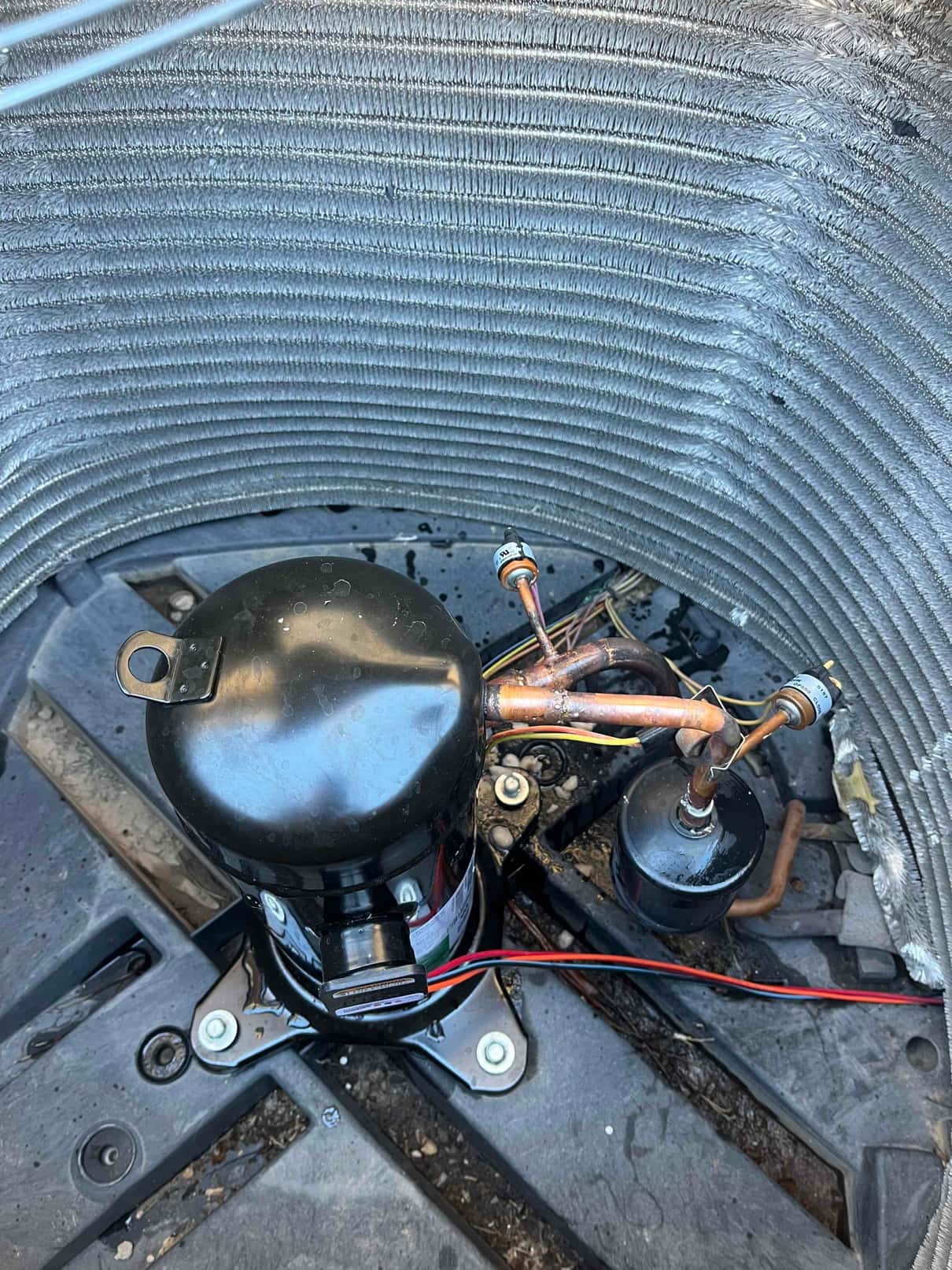 New compressor and bi-flow filter drier installed inside the condenser coil, with cleaned copper brazed connections and secured mounting.