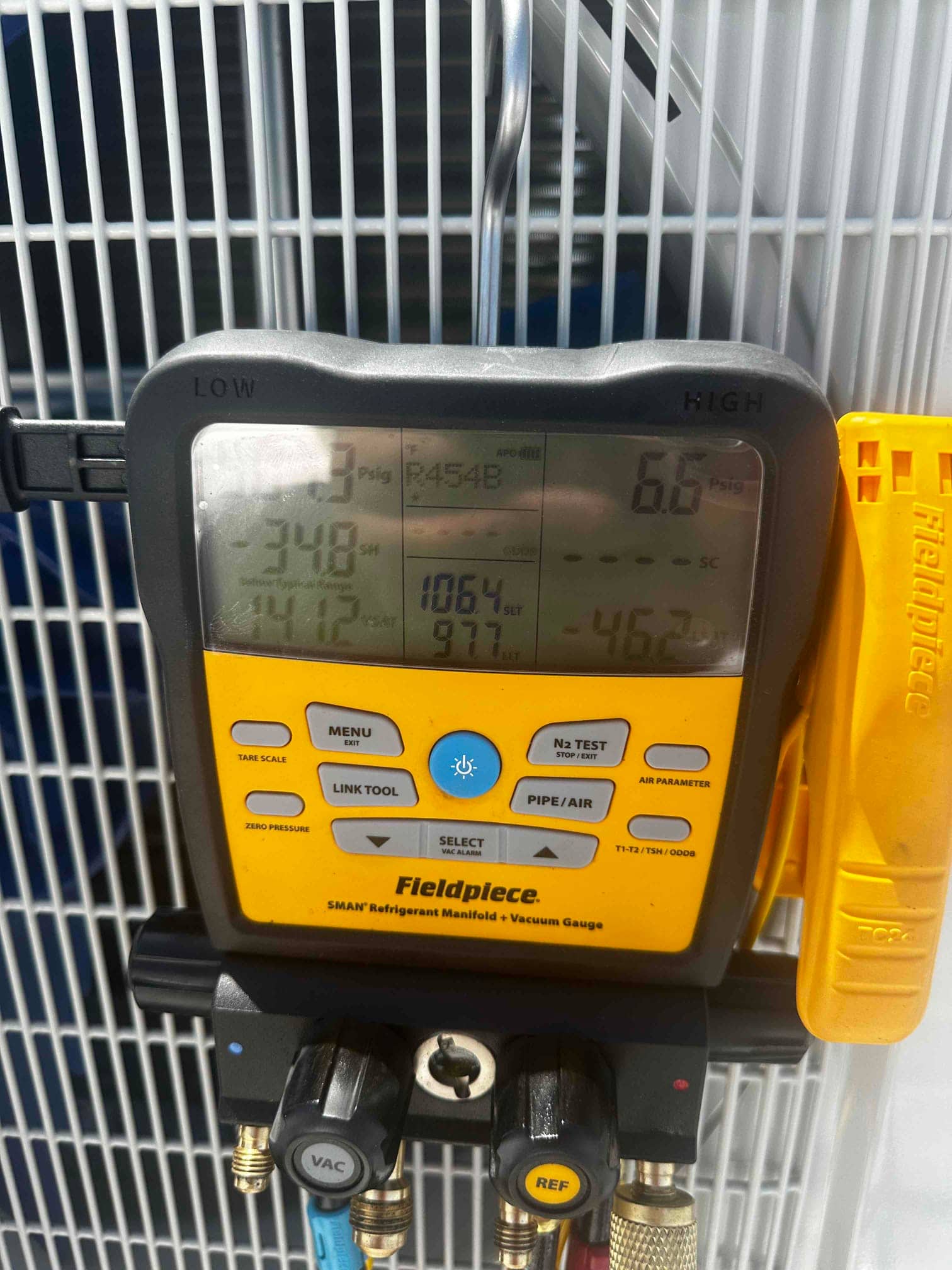 Digital manifold attached at the outdoor unit shows equalized high pressure on both sides during a nitrogen pressure test.