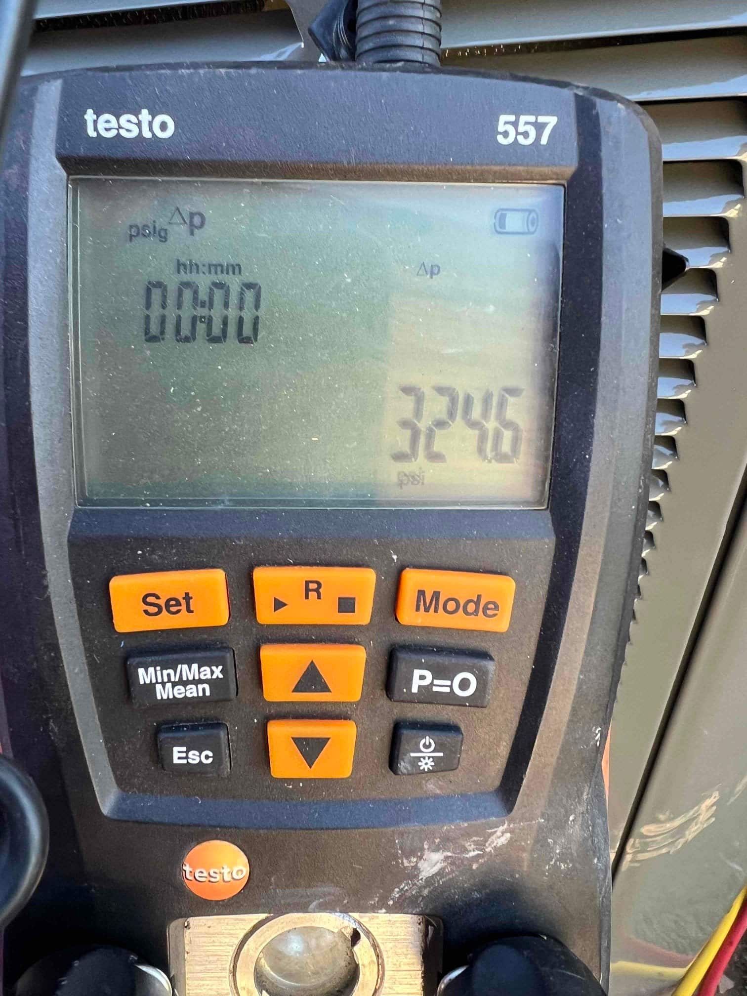 Digital manifold gauge shows equalized pressure at 324.6 psi during a nitrogen pressure test on the new system.