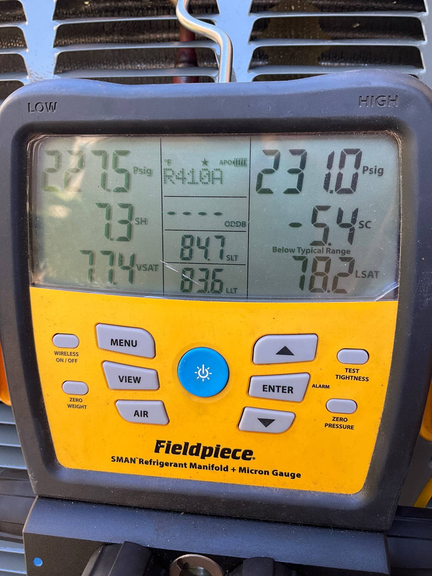 Digital manifold gauges display operating pressures and calculated superheat and subcooling while commissioning the outdoor unit.