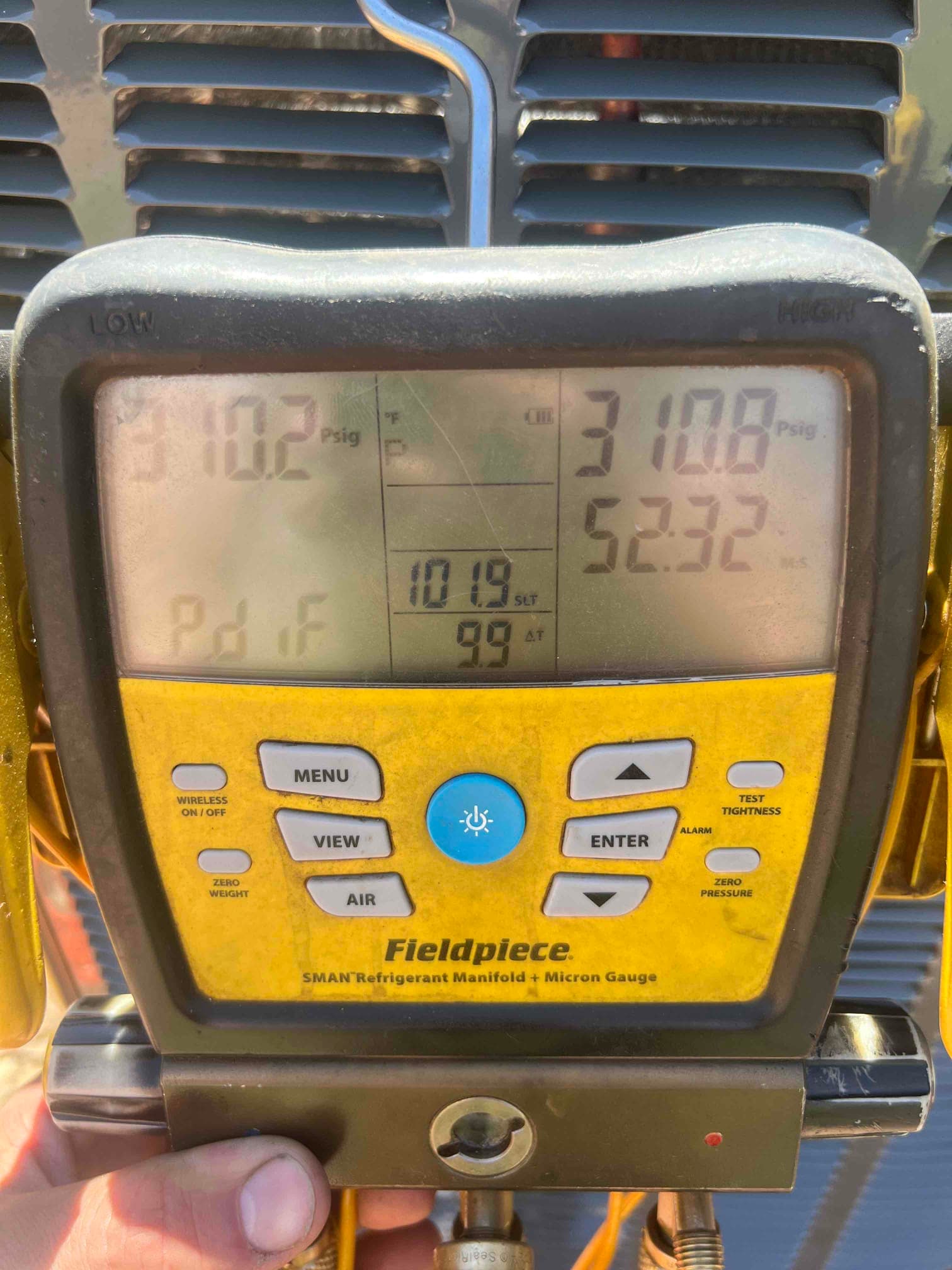 Digital manifold shows equal pressures around 310 PSI on both sides during a nitrogen pressure test at the outdoor unit.