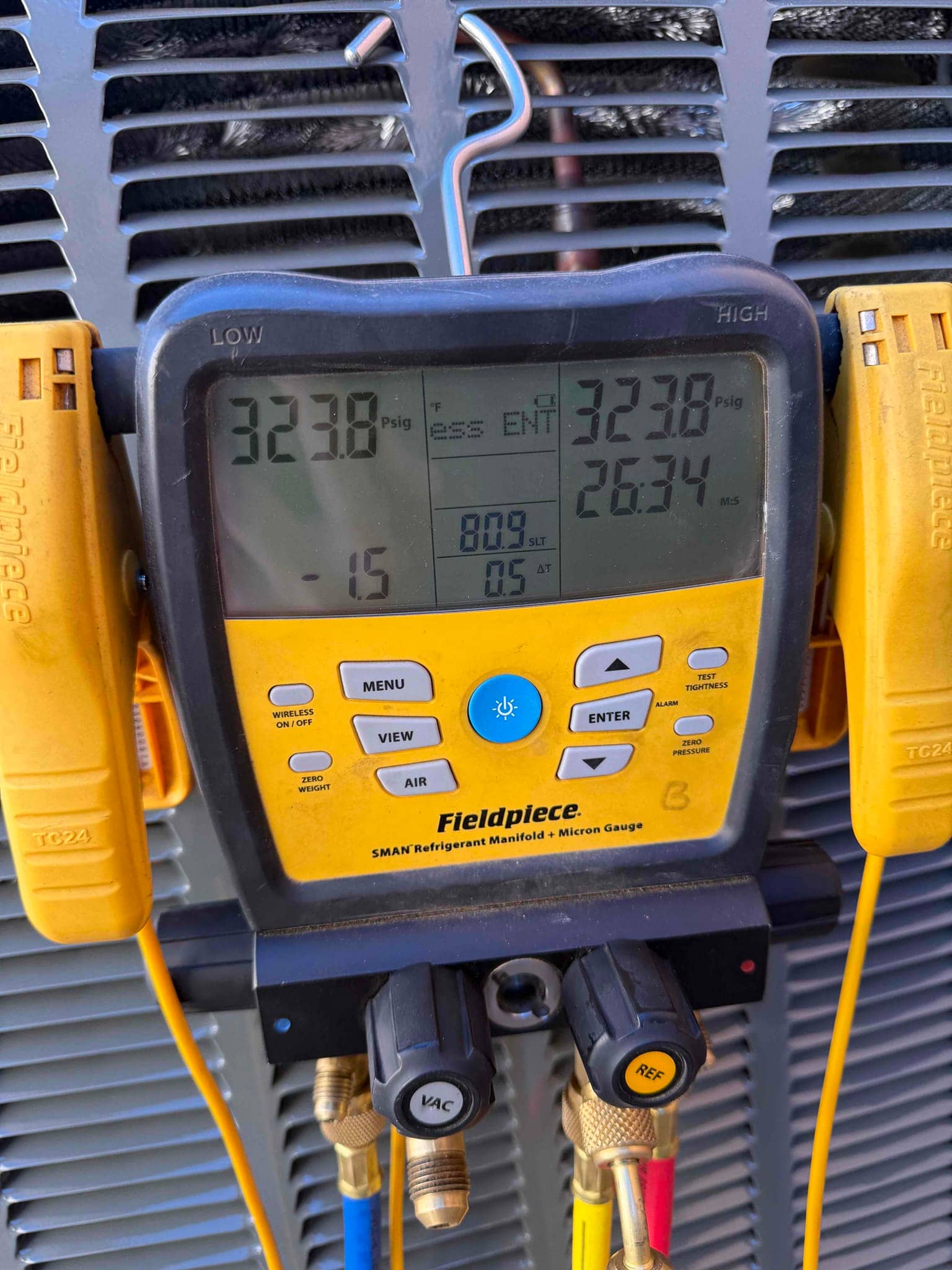 Digital manifold shows equal pressures at 323 PSI on both sides during a nitrogen pressure test of the new system.