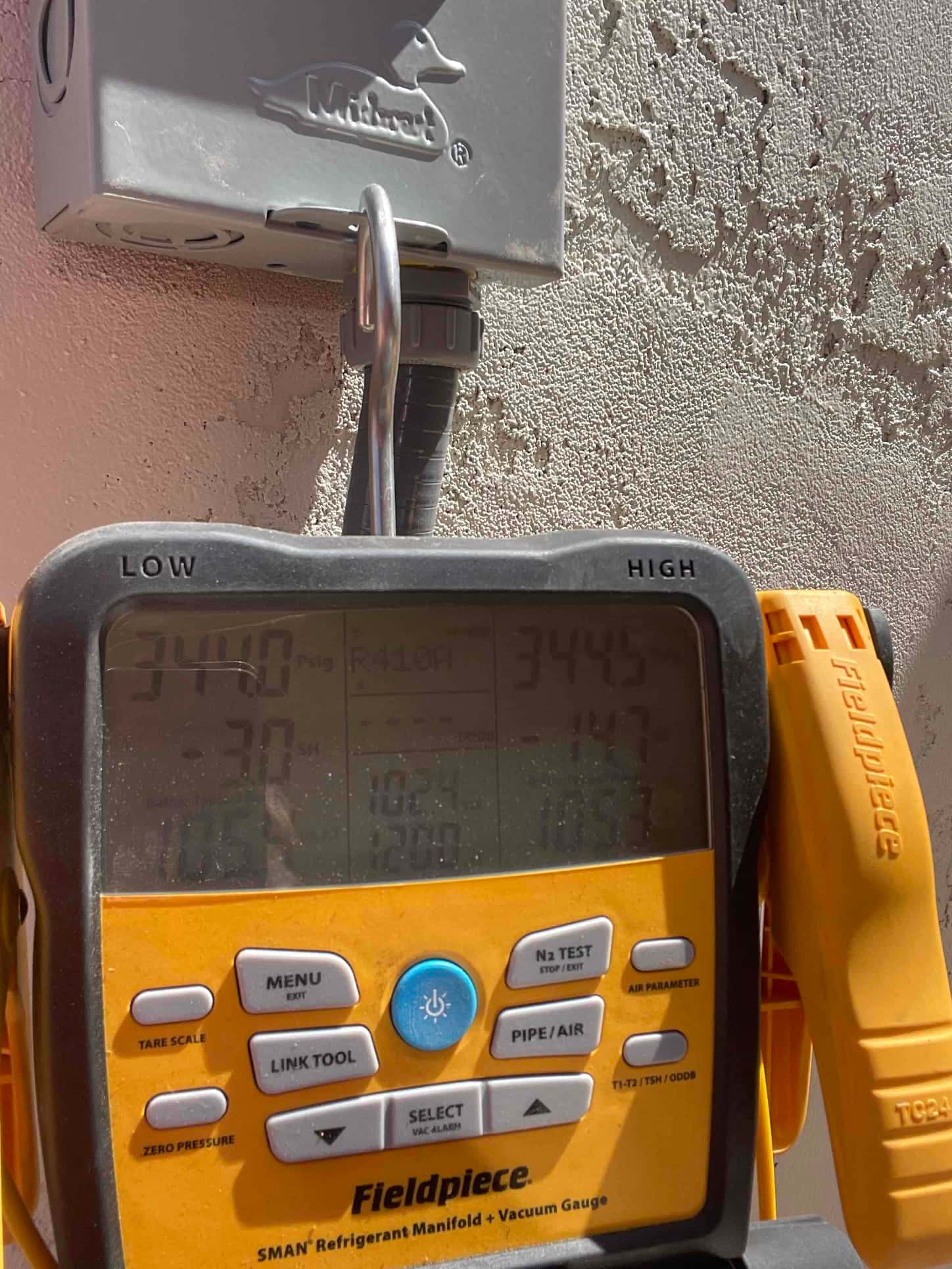 Digital manifold shows equal pressures around 344 PSI on both low and high sides during a nitrogen pressure test.