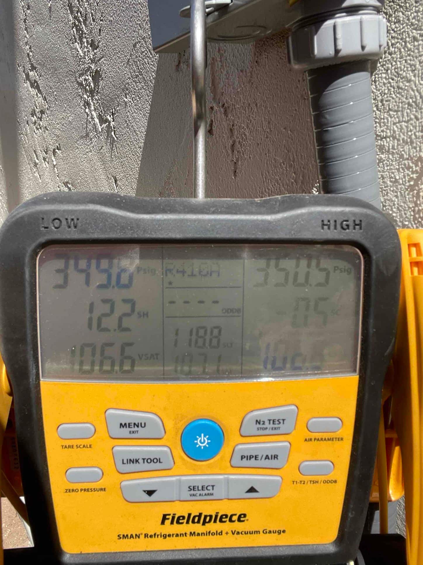 Digital manifold shows equal pressures around 349–350 PSI on both sides during a nitrogen pressure test of the new system.