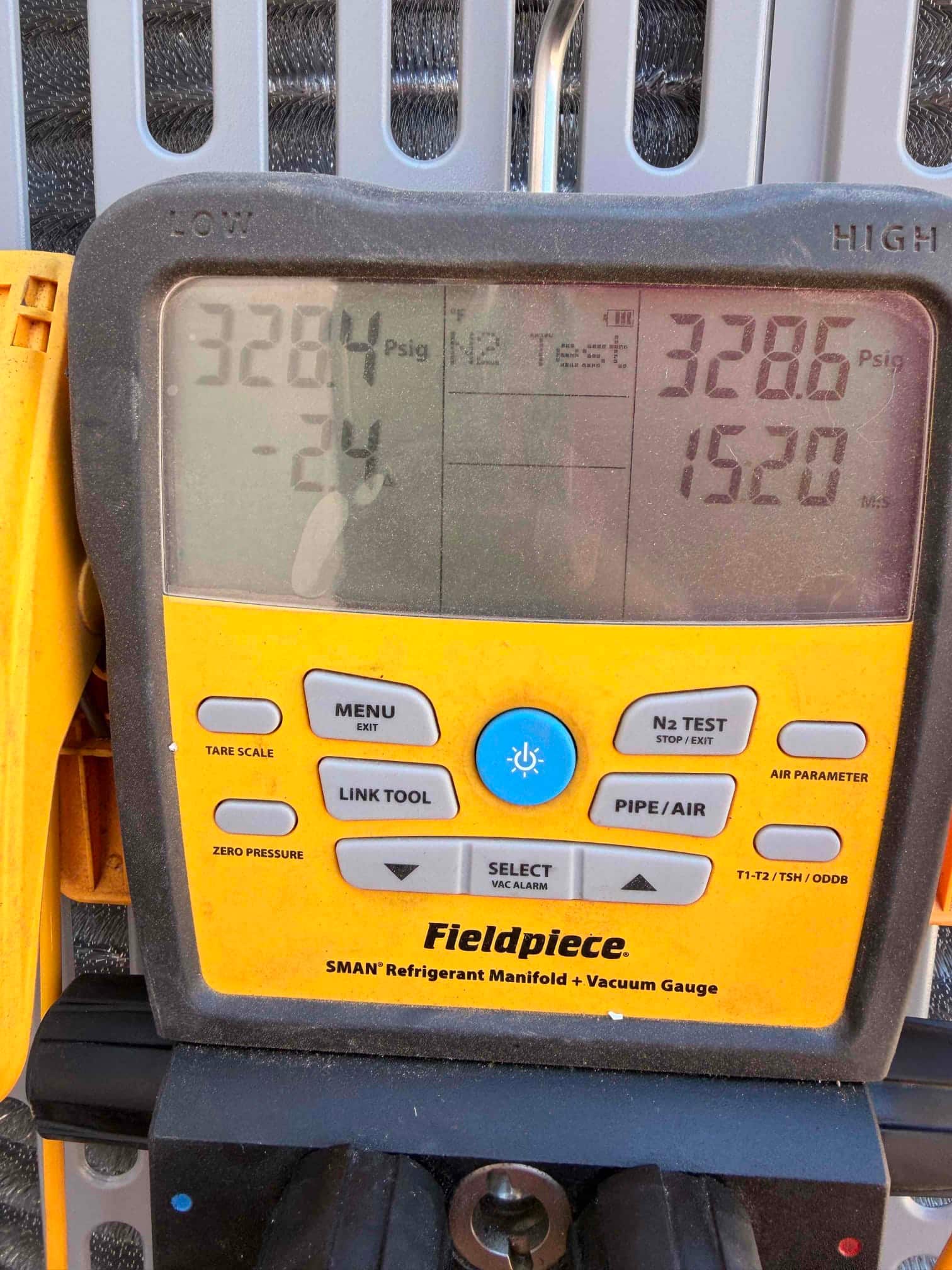Digital manifold shows equal pressures during a nitrogen pressure test on a newly installed HVAC system.