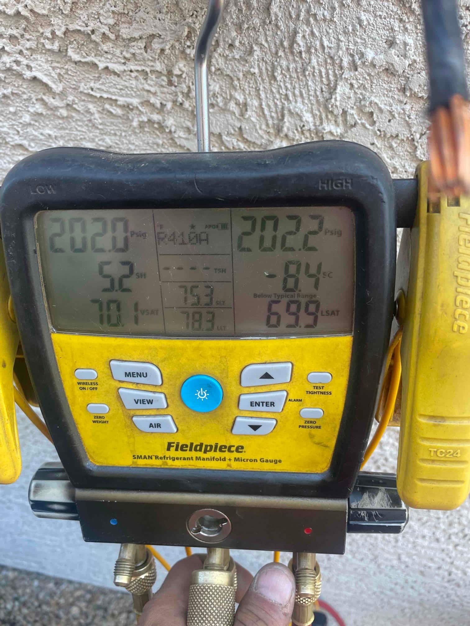 Digital manifold shows both high and low sides holding around 202 PSI during a nitrogen pressure test on the new system.
