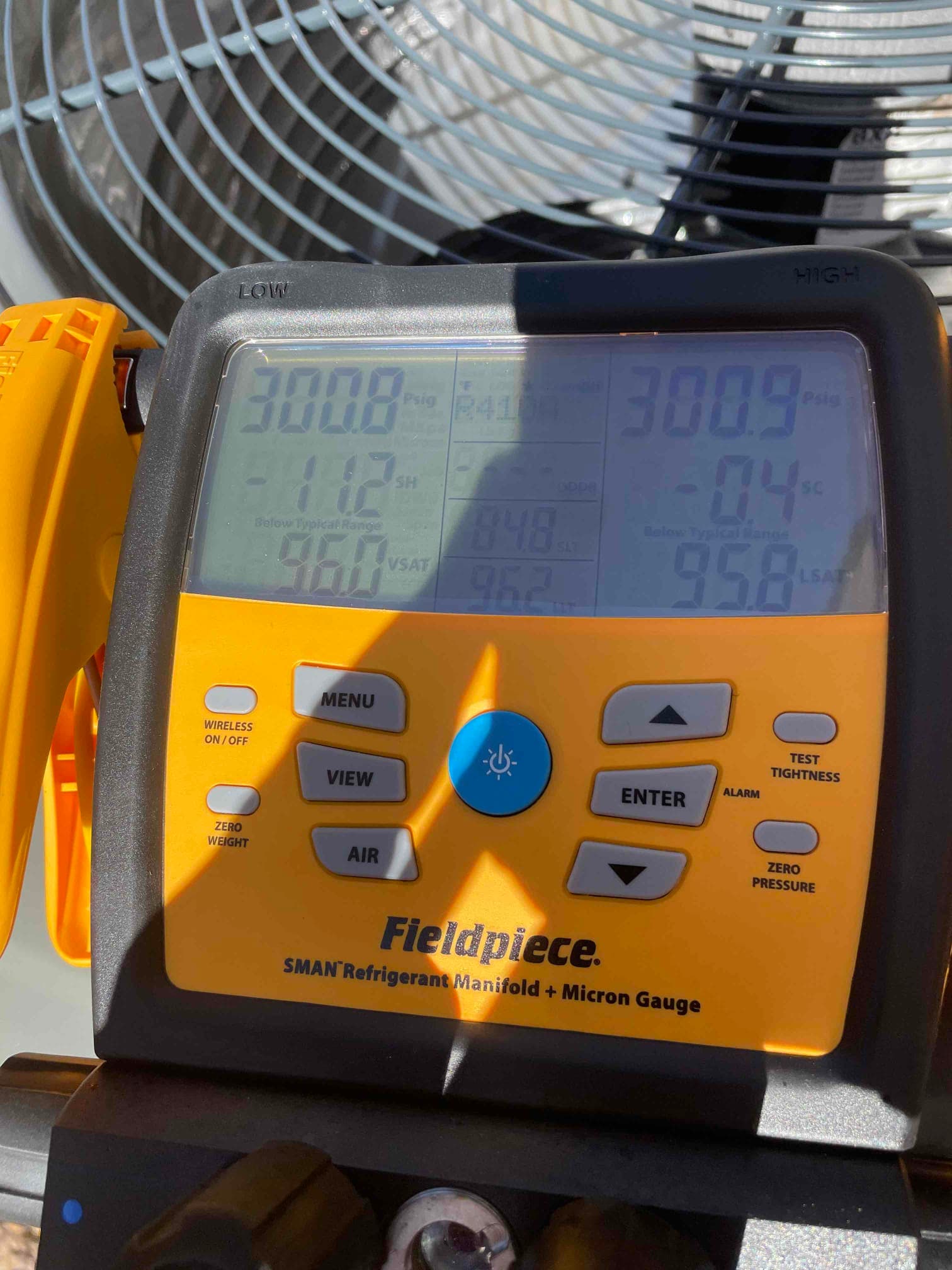 Digital manifold shows both high and low sides holding around 300 PSI during a nitrogen pressure test at the outdoor unit.
