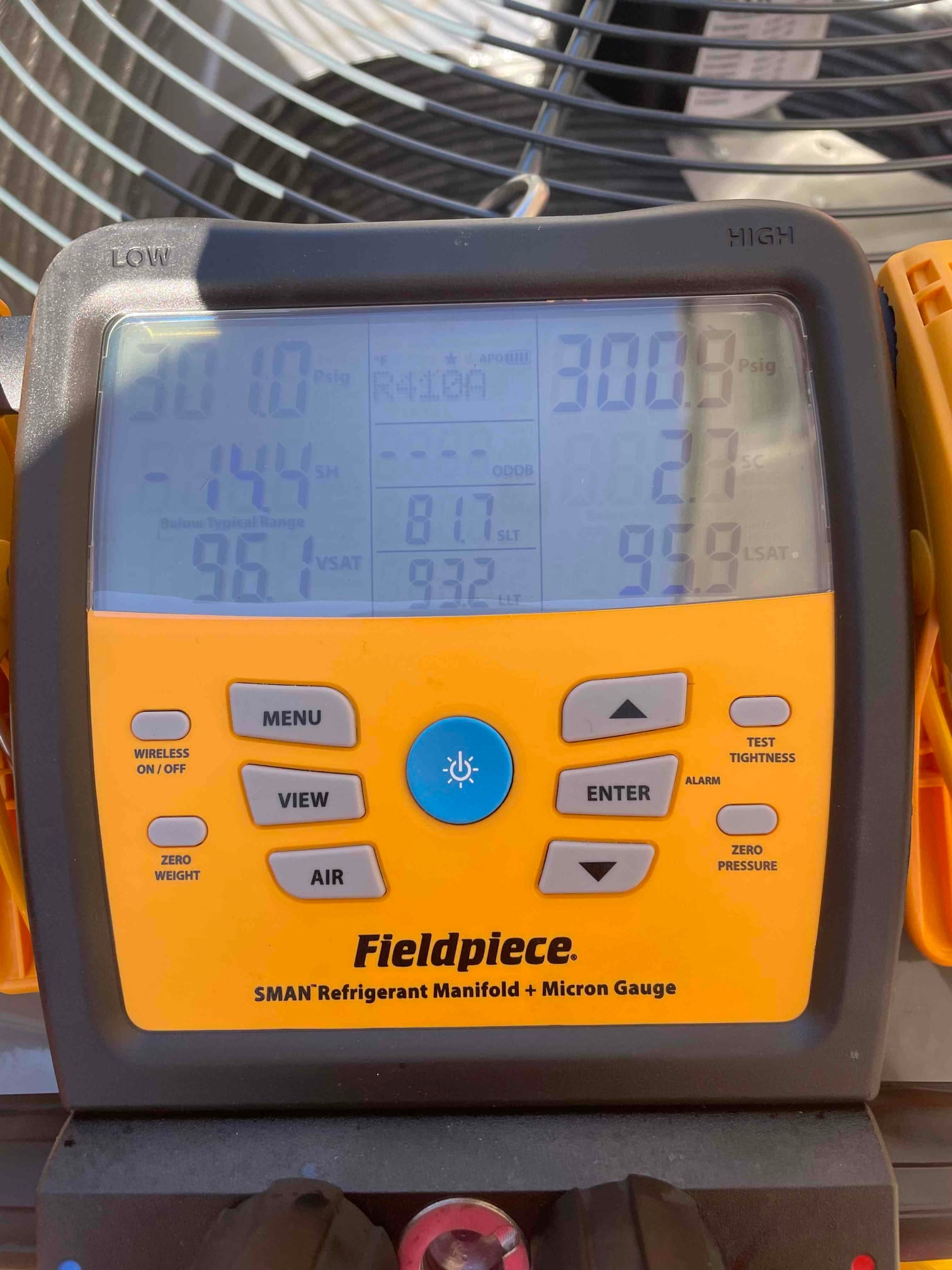 Digital manifold shows system operating pressures with low side at 101 PSIG and high side at 308 PSIG on refrigerant R-410A.