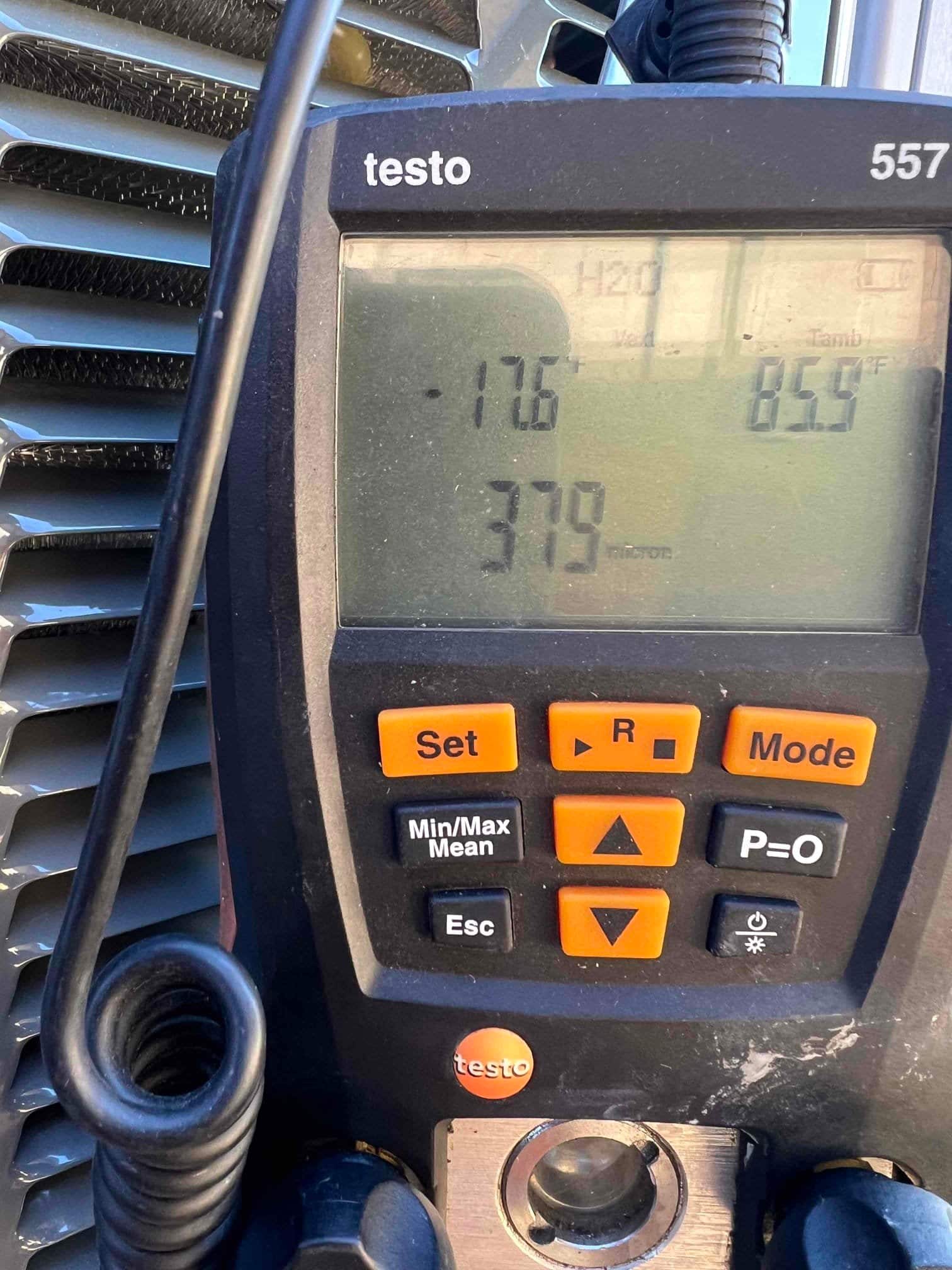 Digital micron gauge displays 379 microns during system evacuation, confirming a deep vacuum before refrigerant charging.