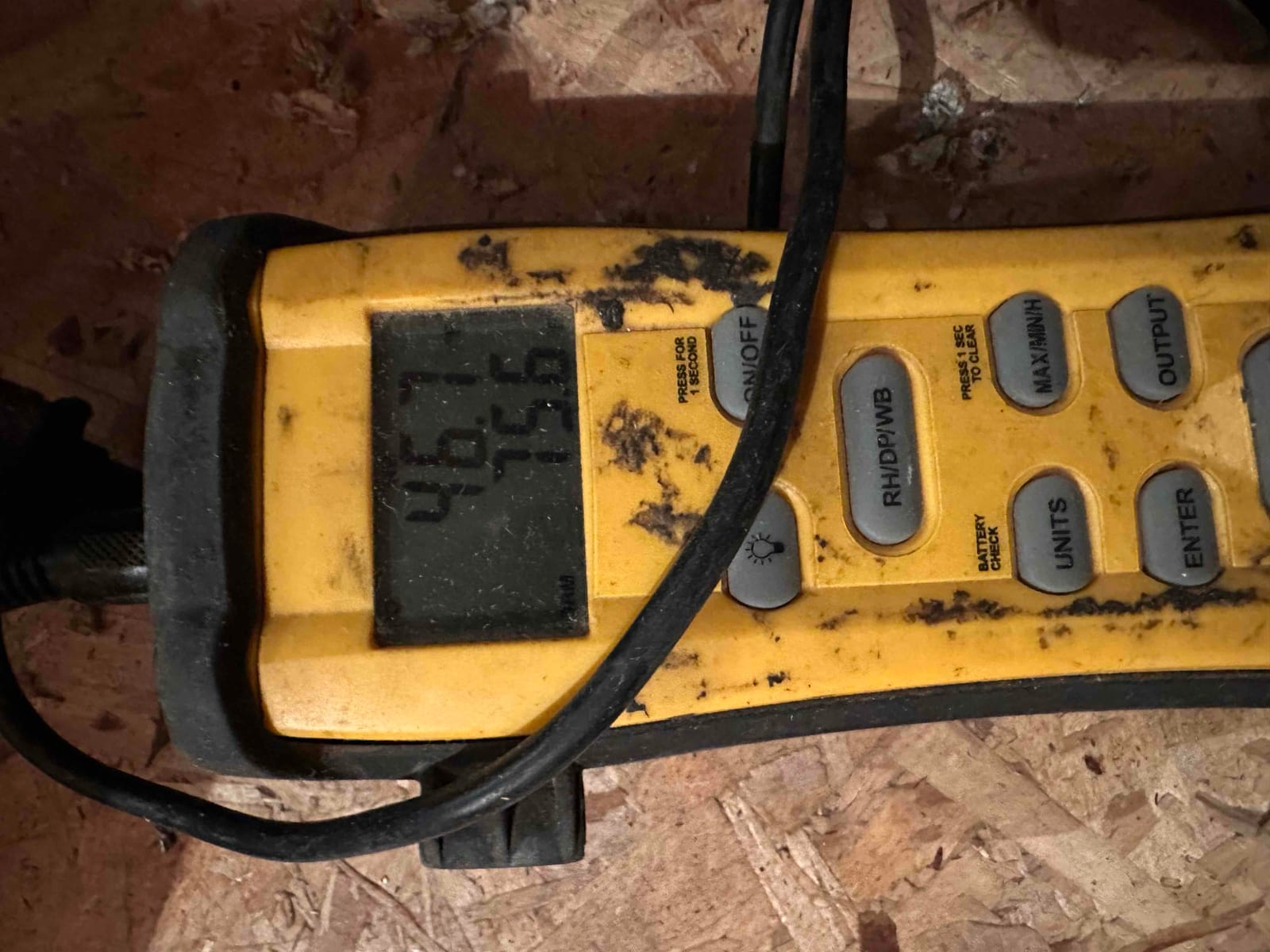 Digital thermometer shows temperatures during air-side checks on a newly installed system inside the mechanical area.