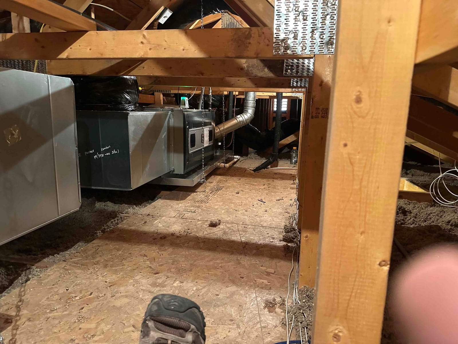 New furnace and evaporator assembly installed in the attic with suspended platform, sealed duct transitions, and connected flue and ductwork.