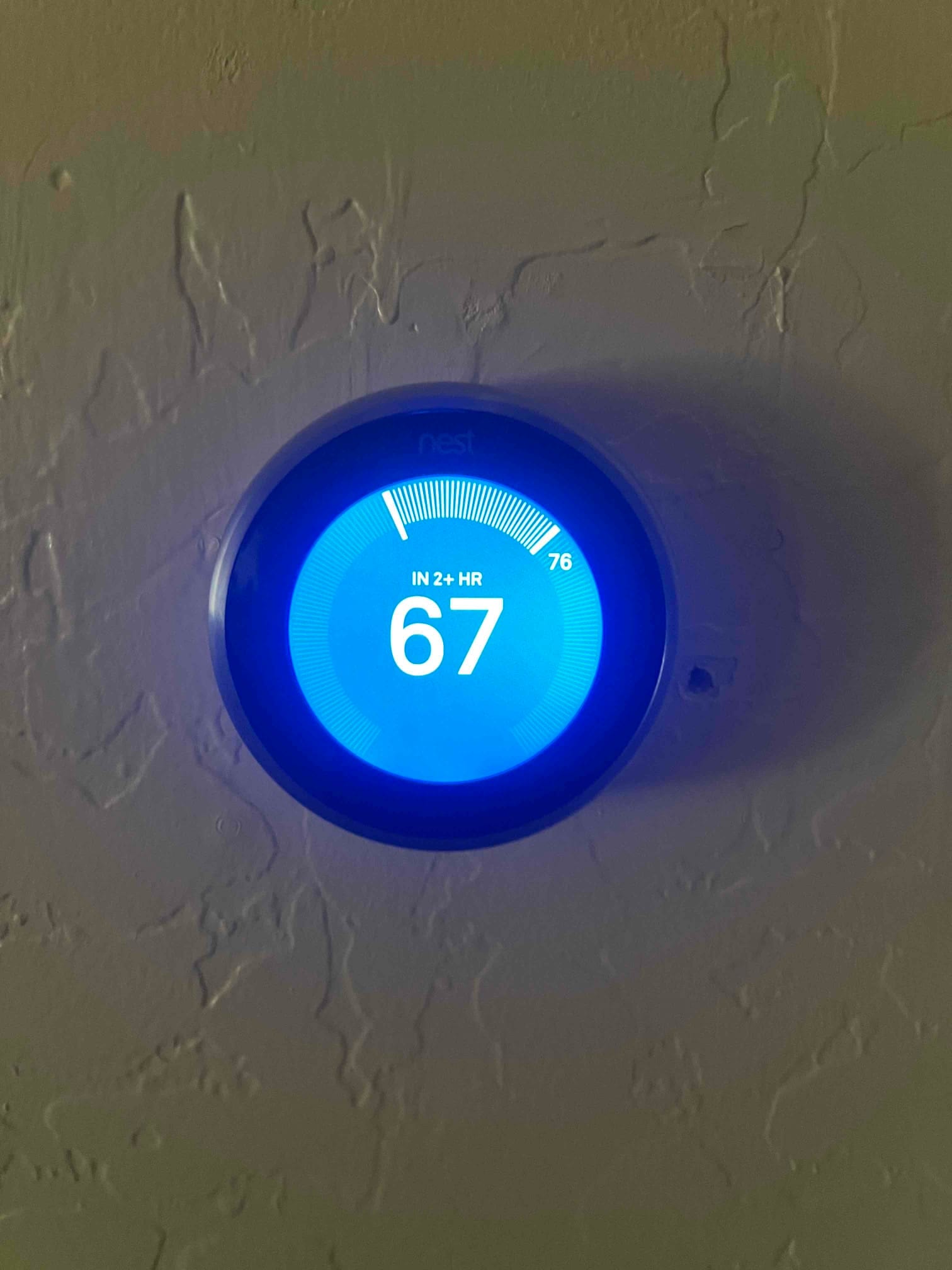 Smart thermostat display shows a 67 °F cooling setpoint with the system indicating cooling progress over the next two hours.