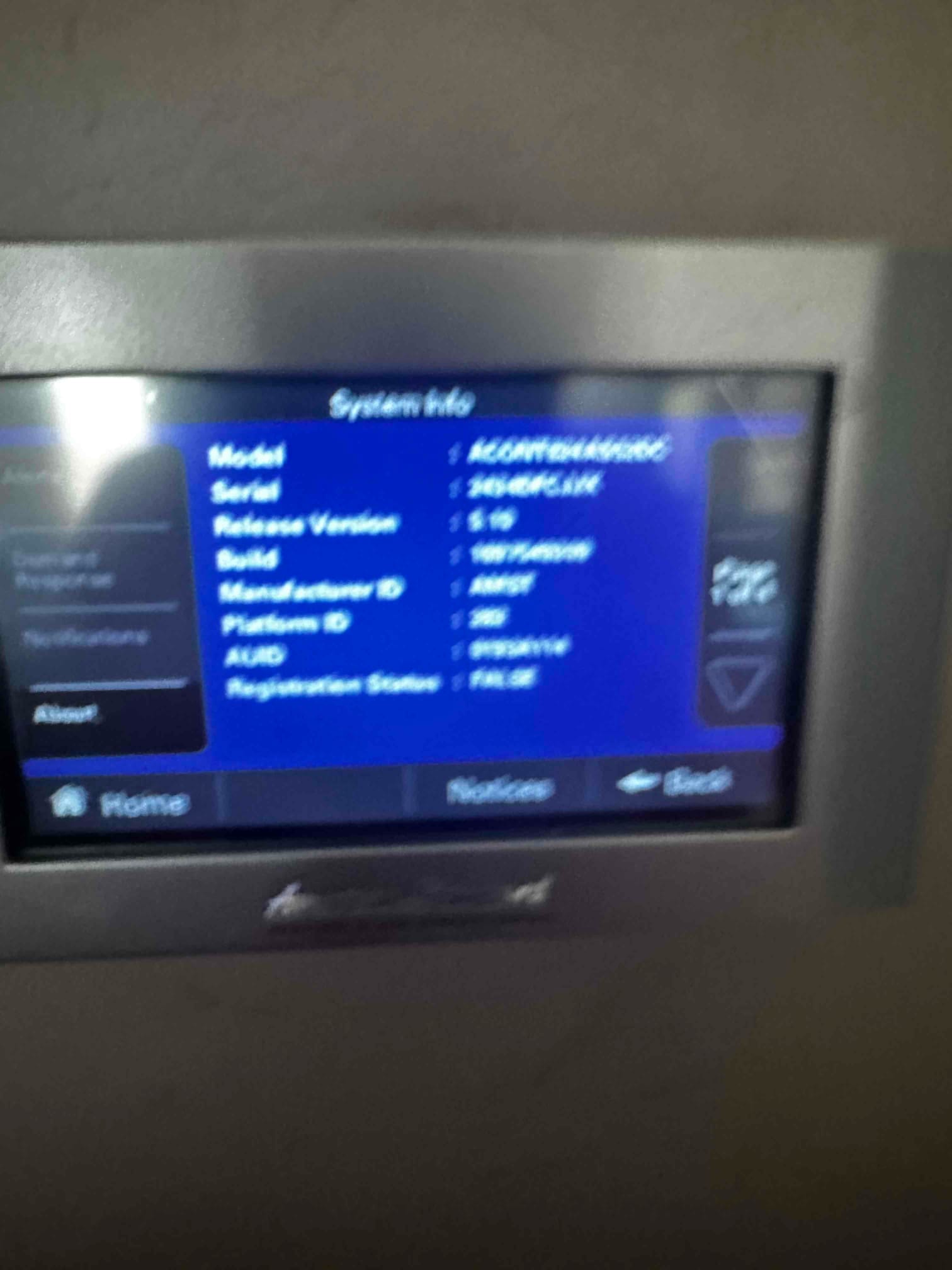 Thermostat or control interface displays system information on screen, showing menu options and navigation buttons during setup.