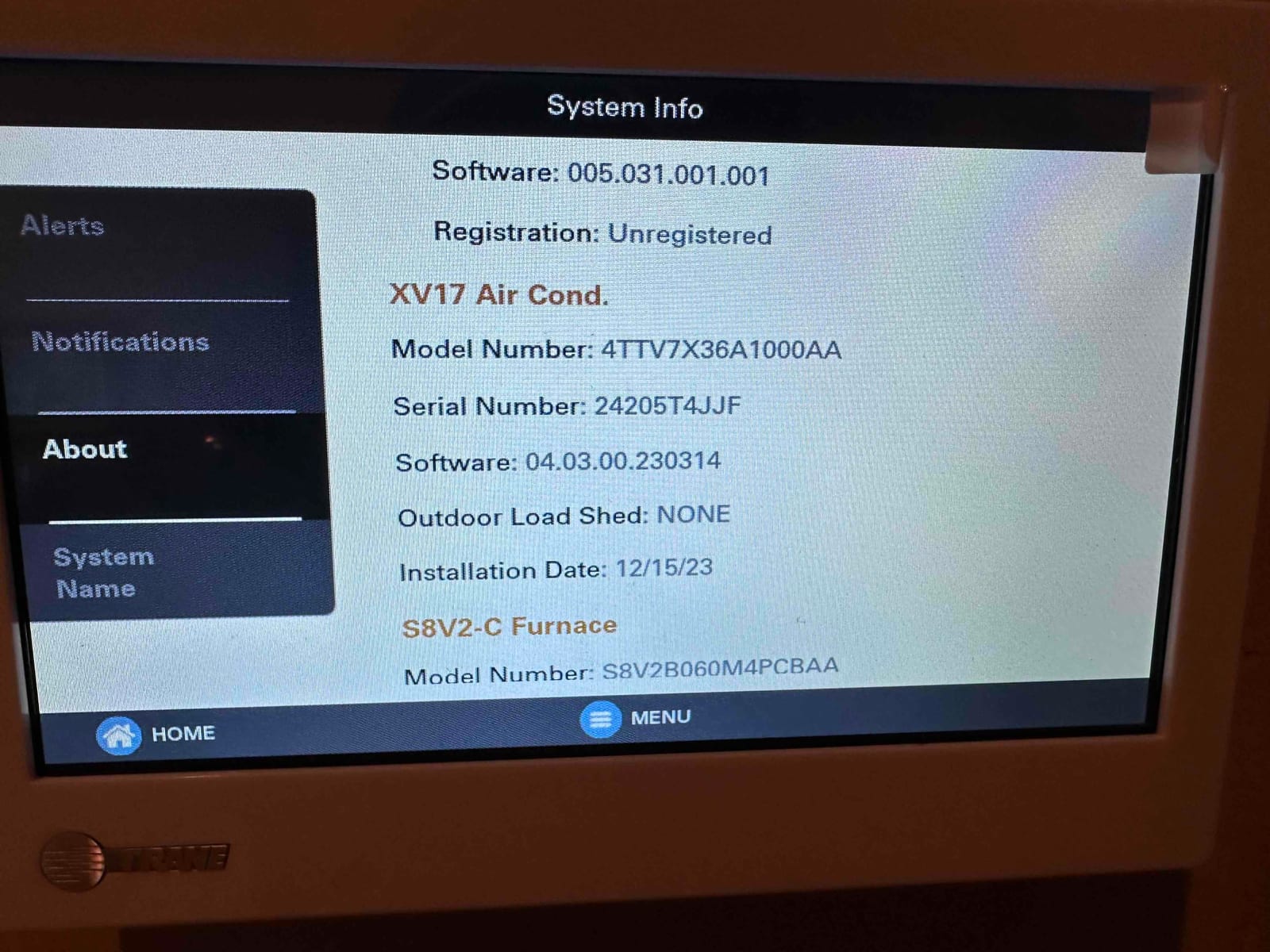 Thermostat system info screen displays equipment details and installation date during setup of the new HVAC system.