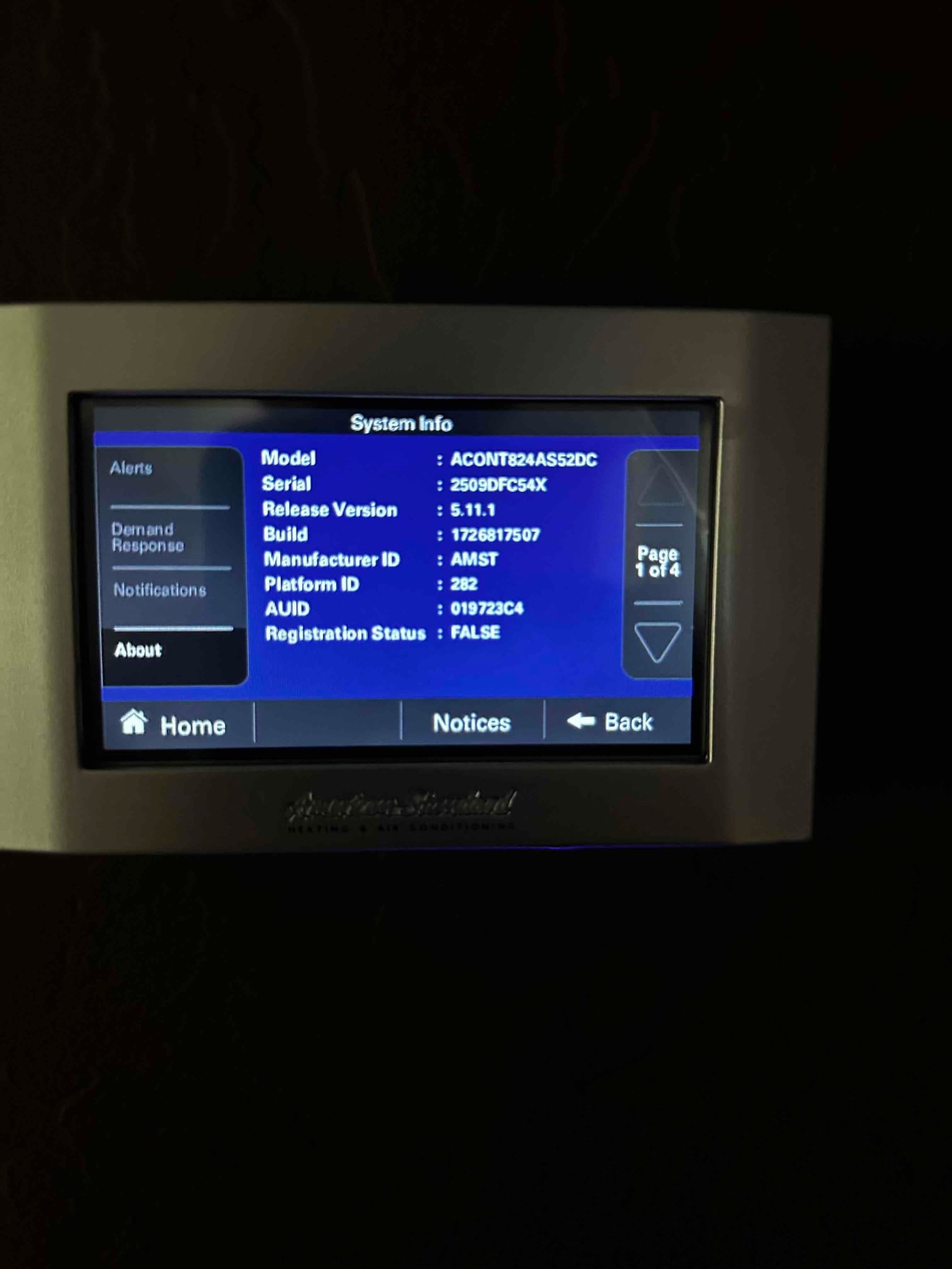 Thermostat touchscreen displays system information and menu options after installation, confirming control interface operation at the new HVAC system.