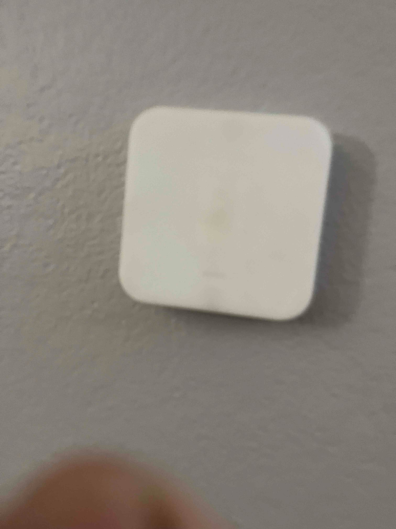 Wall-mounted thermostat or temperature sensor installed on a finished interior wall, completing the control setup for the new HVAC system.