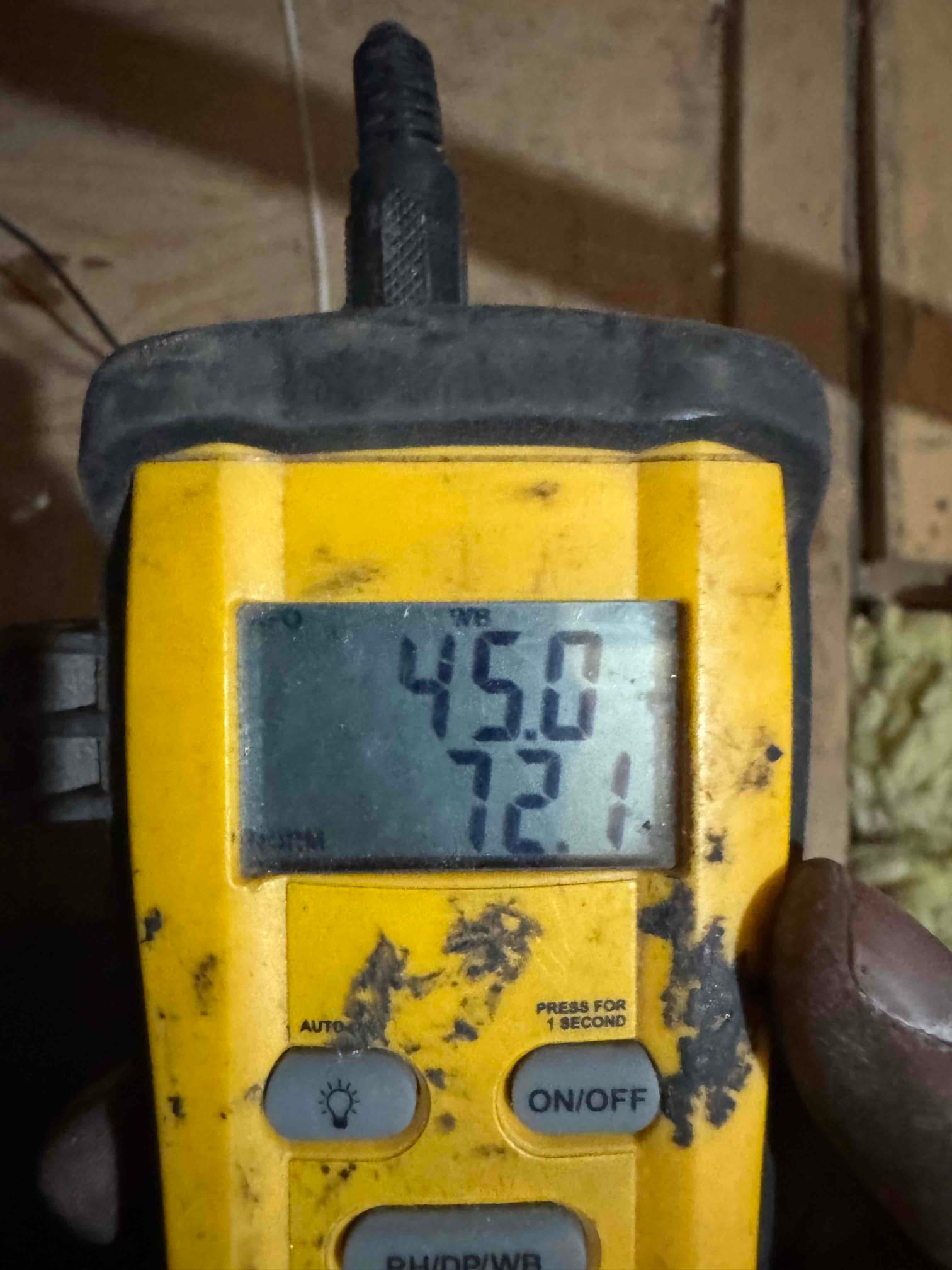 Digital thermometer displays 72.1 degrees, documenting return air temperature during commissioning of the new system.