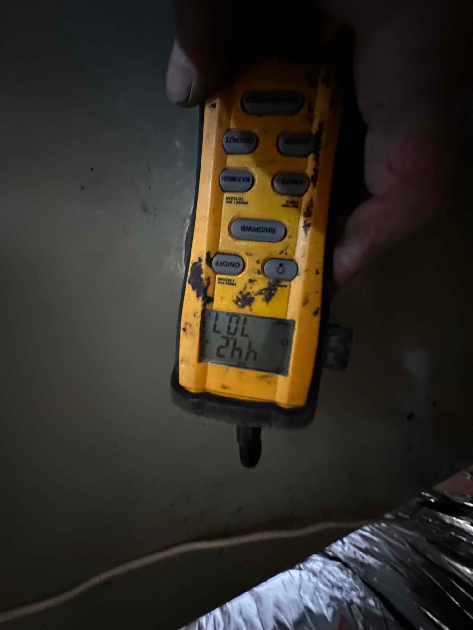 Digital vacuum gauge connected during system evacuation; display is active but the micron value is not clearly readable.