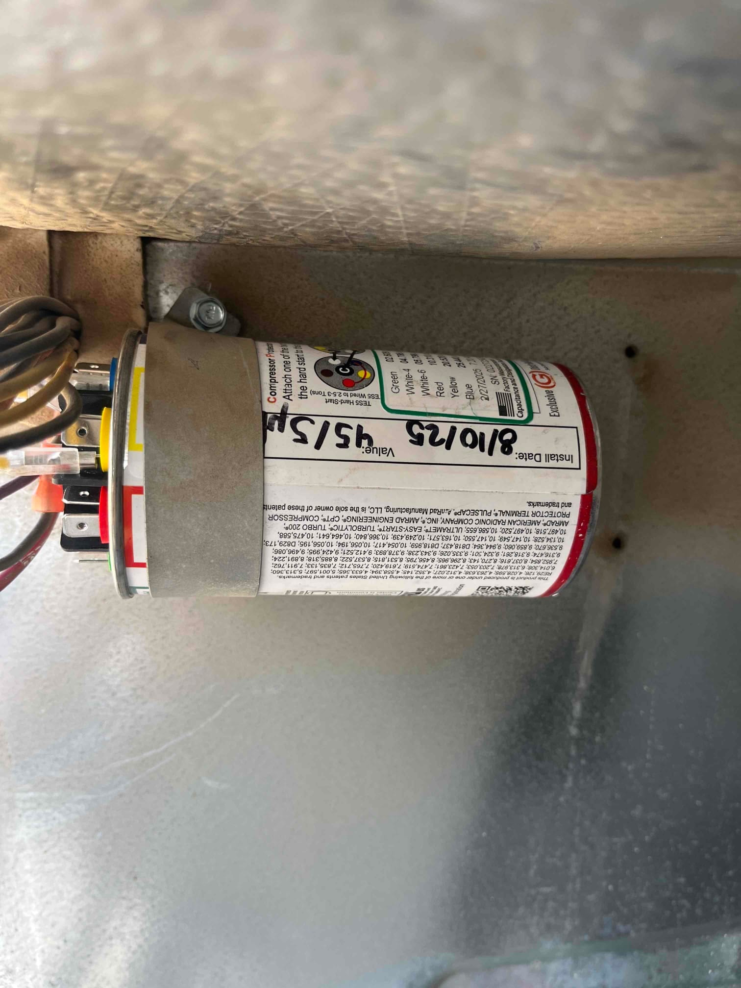 New dual run capacitor installed inside the condenser, with clearly labeled terminals and printed rating 45/5 μF on the can.