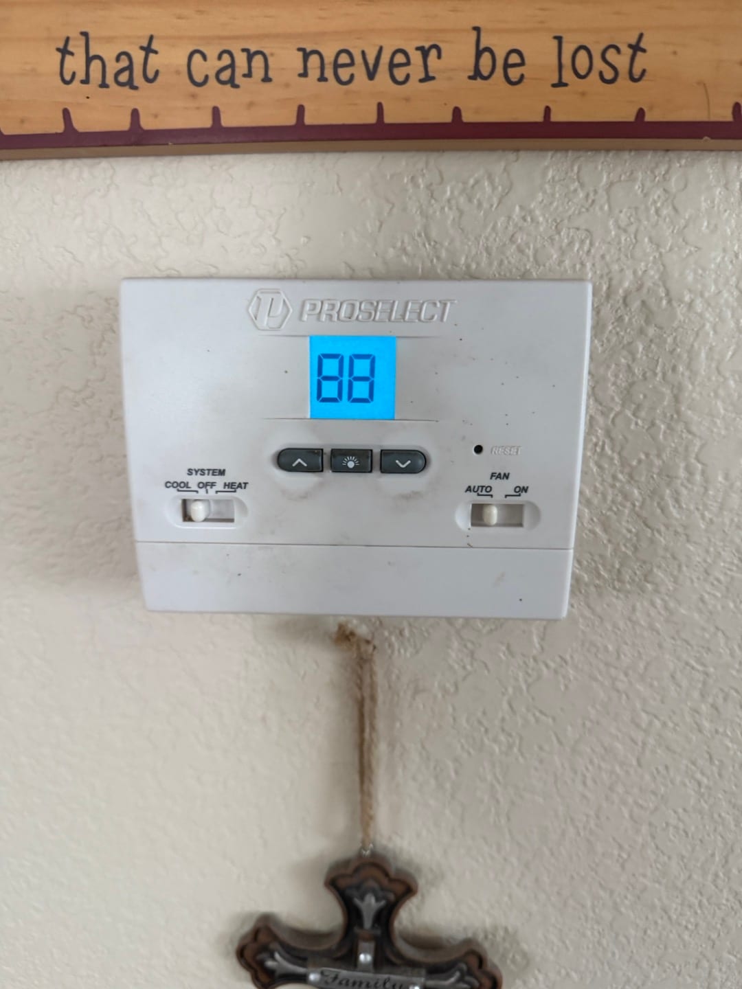 Wall-mounted digital thermostat displays 88 with system and fan mode switches visible below the screen.