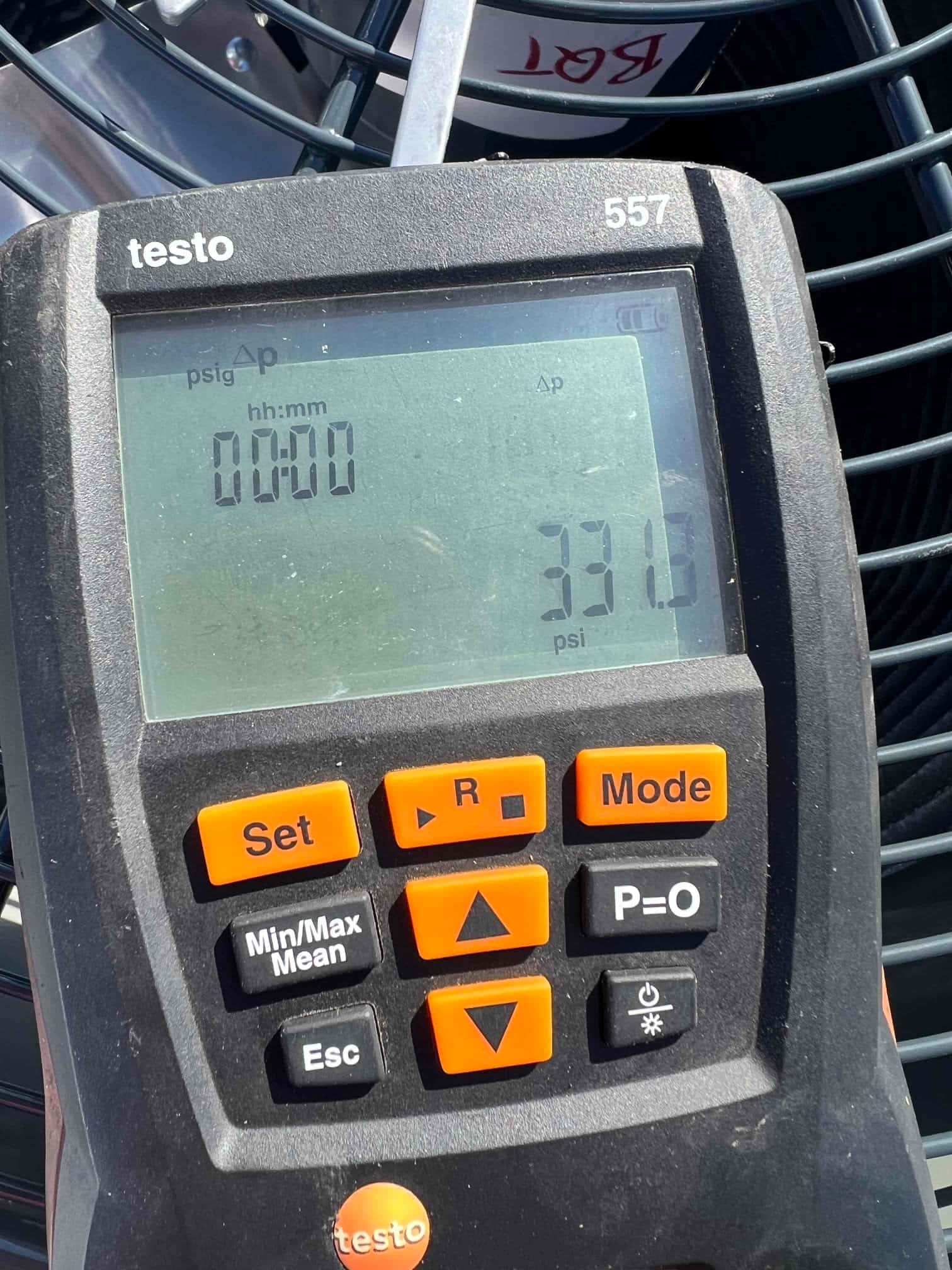 Digital manifold gauge shows equalized system pressure during nitrogen pressure test, with display reading 331 psi.