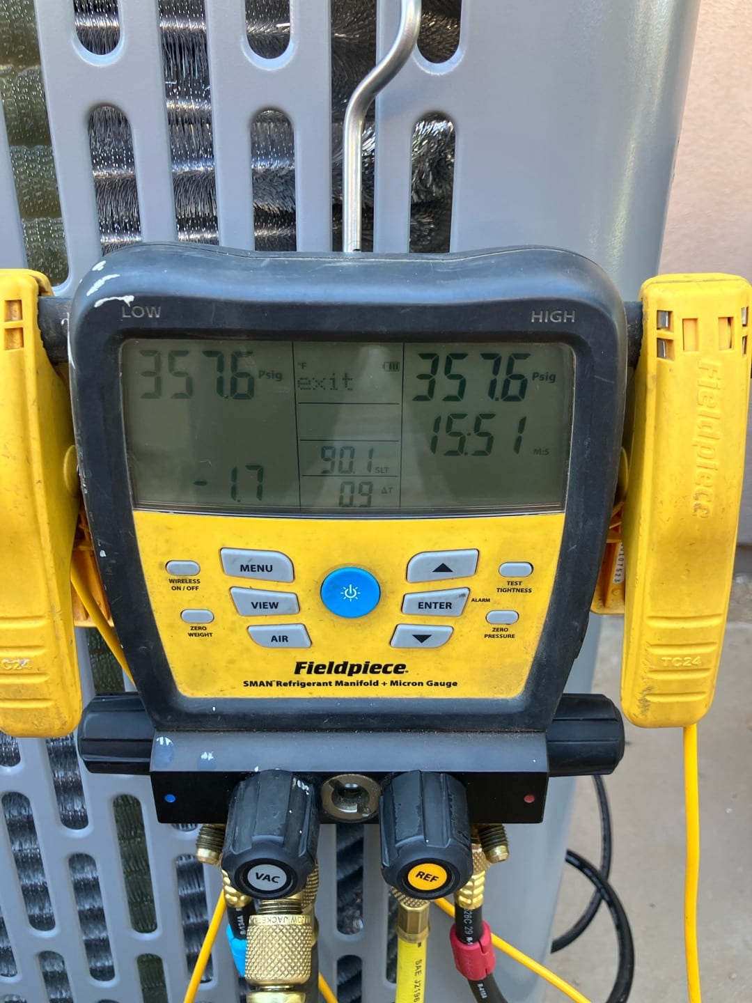 Digital manifold shows equal pressures of 357.6 PSI on both sides during a nitrogen pressure test at the outdoor unit.