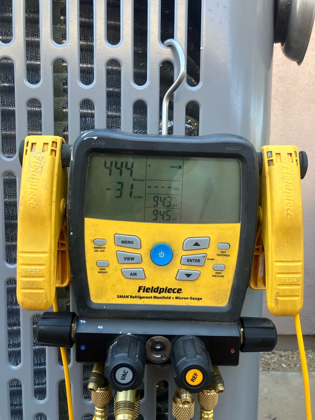 Digital manifold shows both high and low sides at 444 PSI, documenting a nitrogen pressure test on the newly installed system.