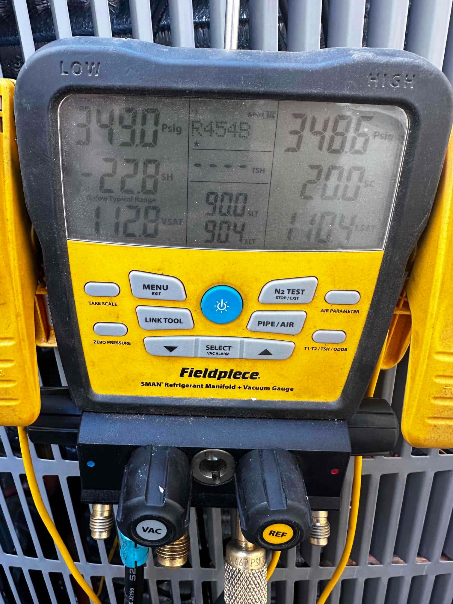 Digital manifold shows both high and low sides holding around 348–349 PSI during a nitrogen pressure test on the new system.