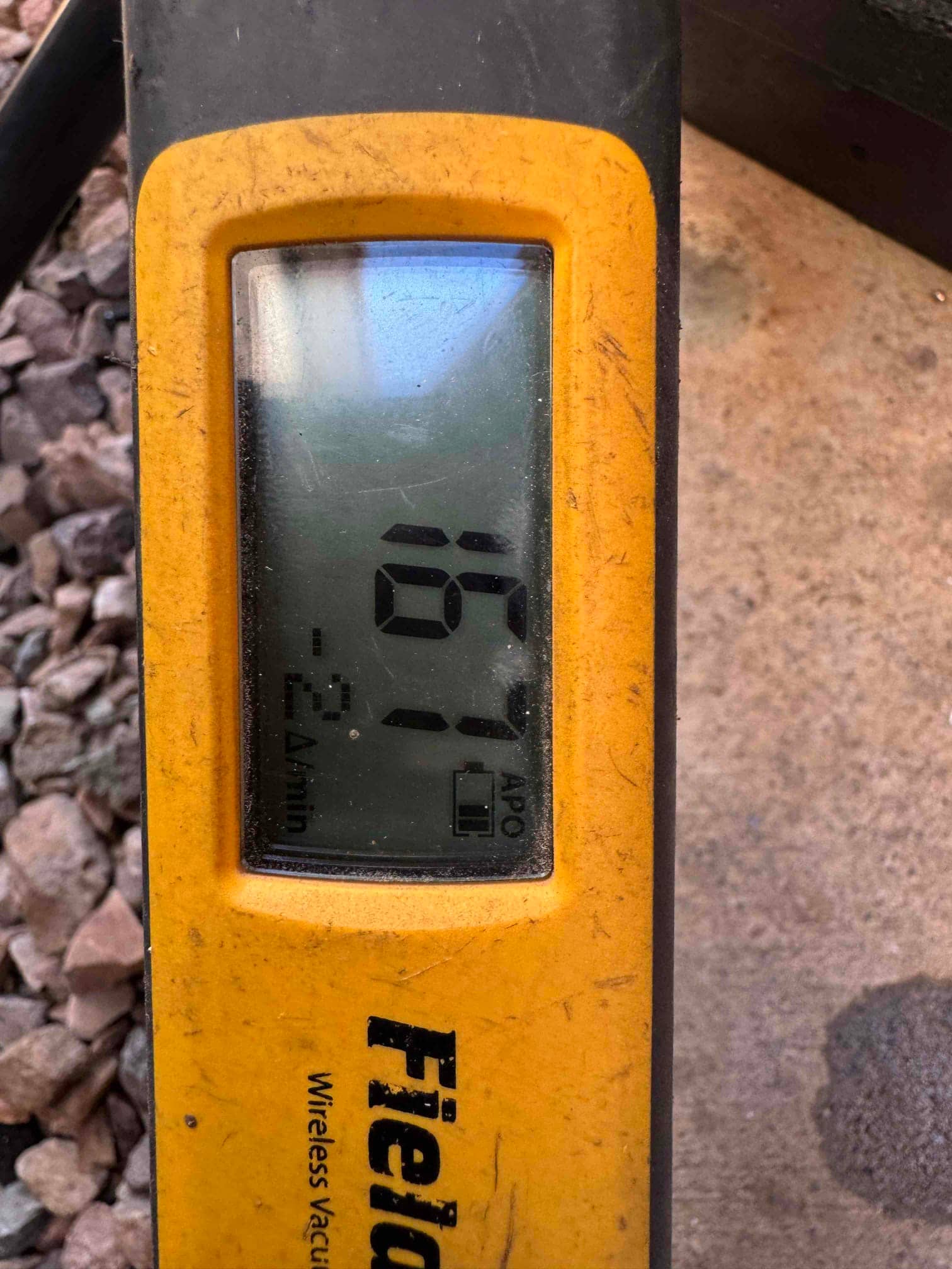 Digital micron gauge displays 167 microns, confirming a deep evacuation on the newly installed HVAC system before charging.