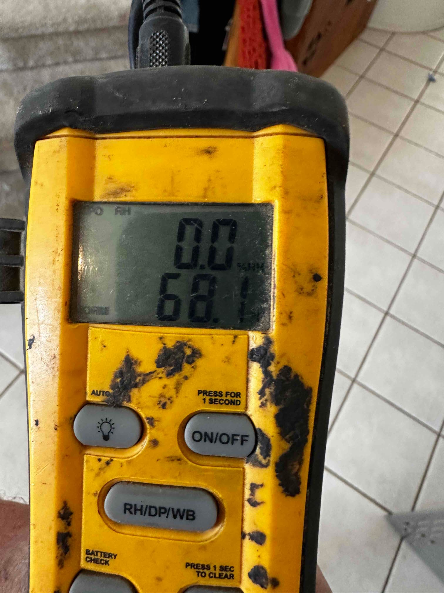 Digital thermometer displays 68.1 degrees Fahrenheit during air temperature check as part of system commissioning.