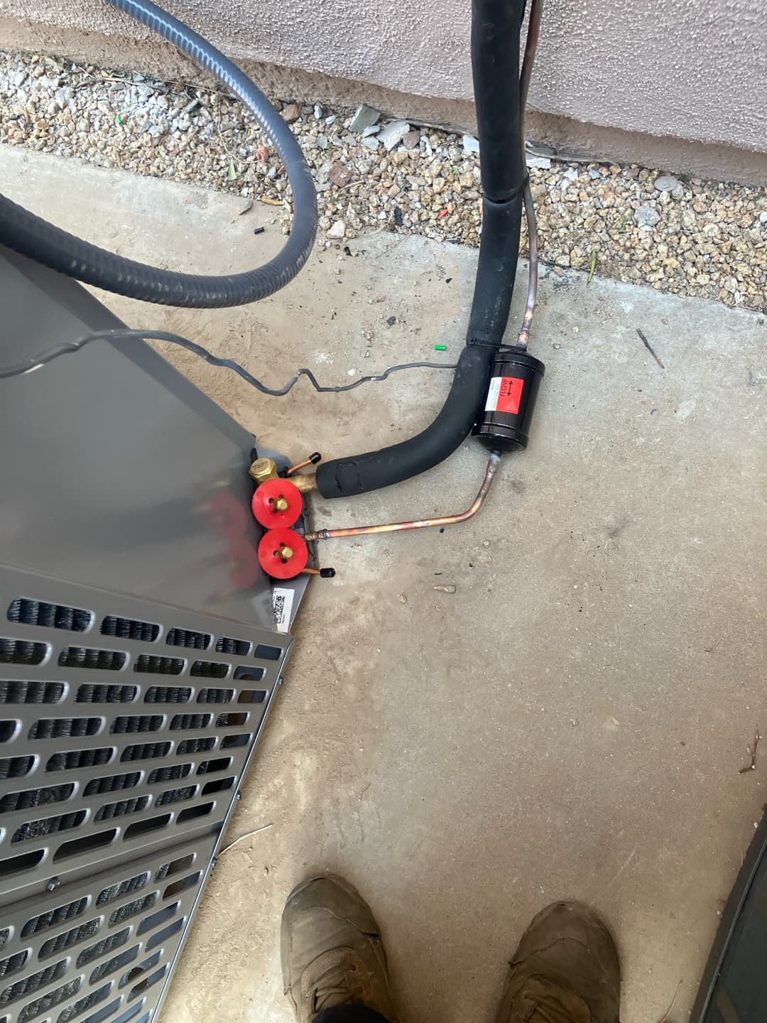 Outdoor condenser connections with insulated suction line and inline filter-drier installed on the liquid line at the unit.