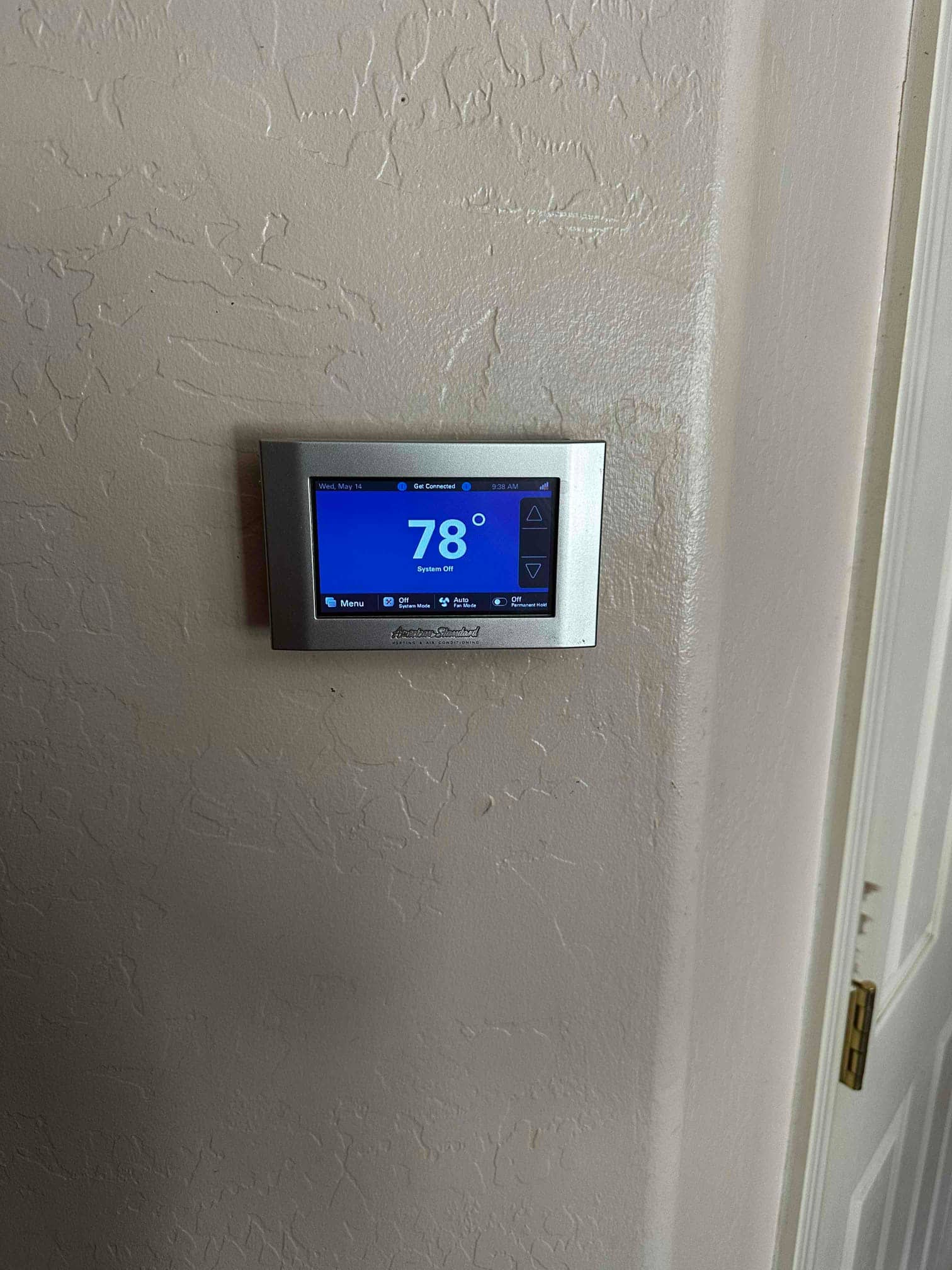 Wall-mounted touchscreen thermostat displays 78 degrees with the system off after the new installation.