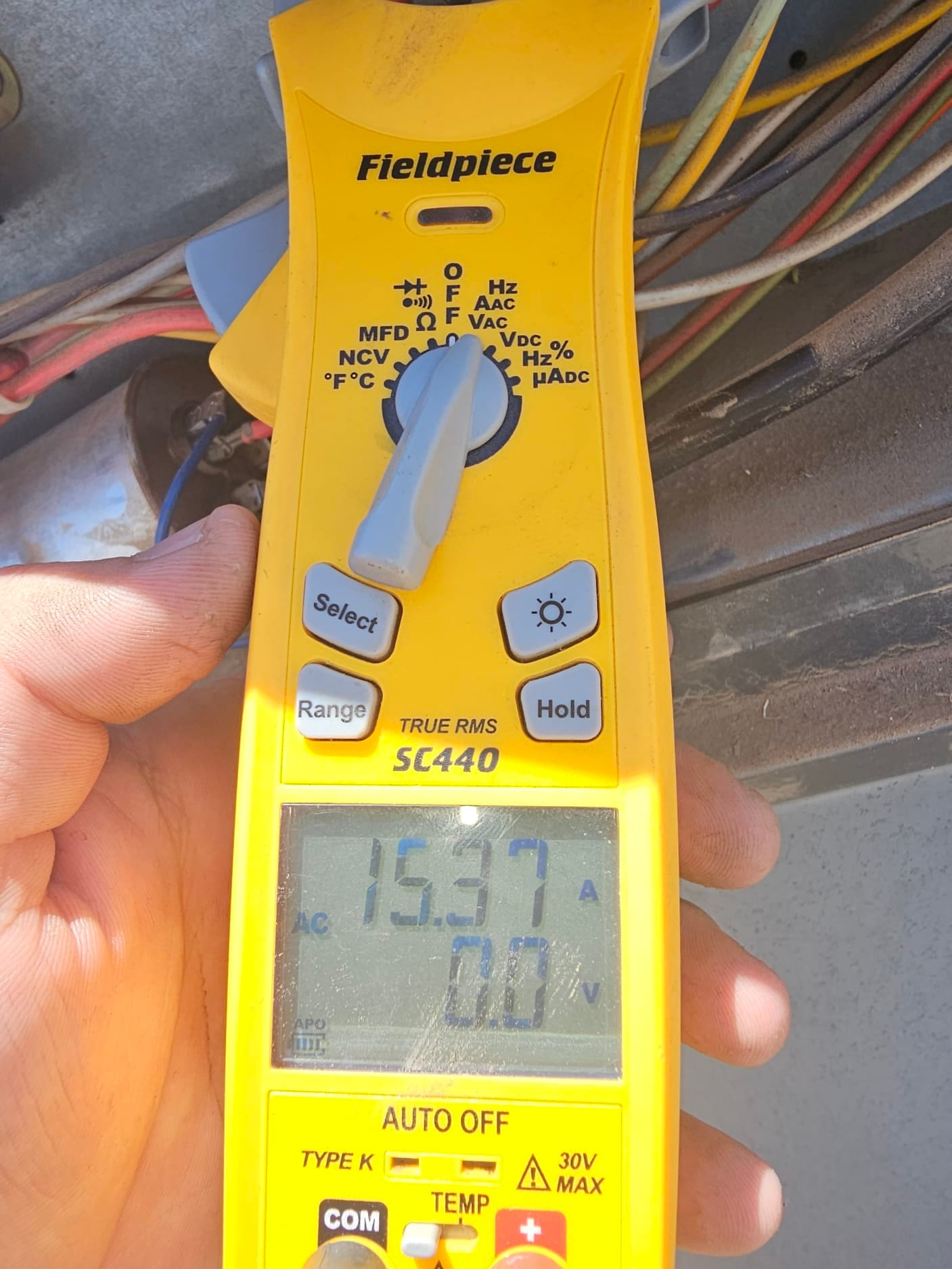 Diagnostic instrument display shows 15.37 A.