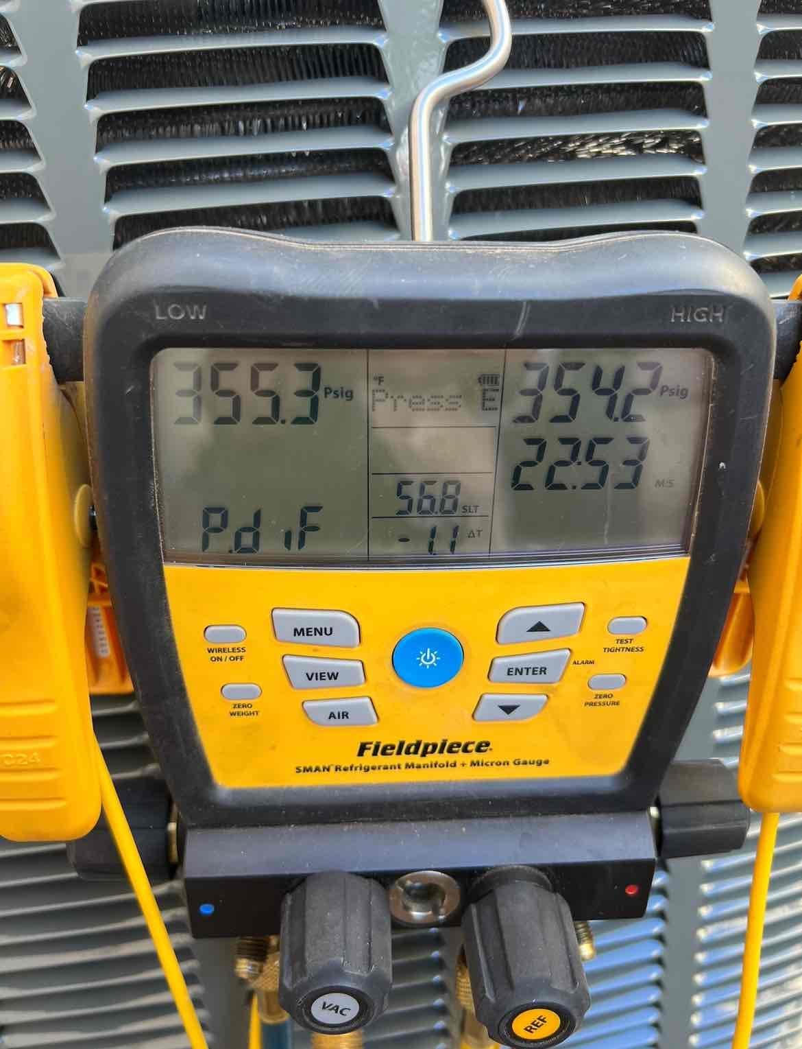 Digital manifold shows equalized pressures around 355 PSI on both sides during a nitrogen pressure test at the outdoor unit.