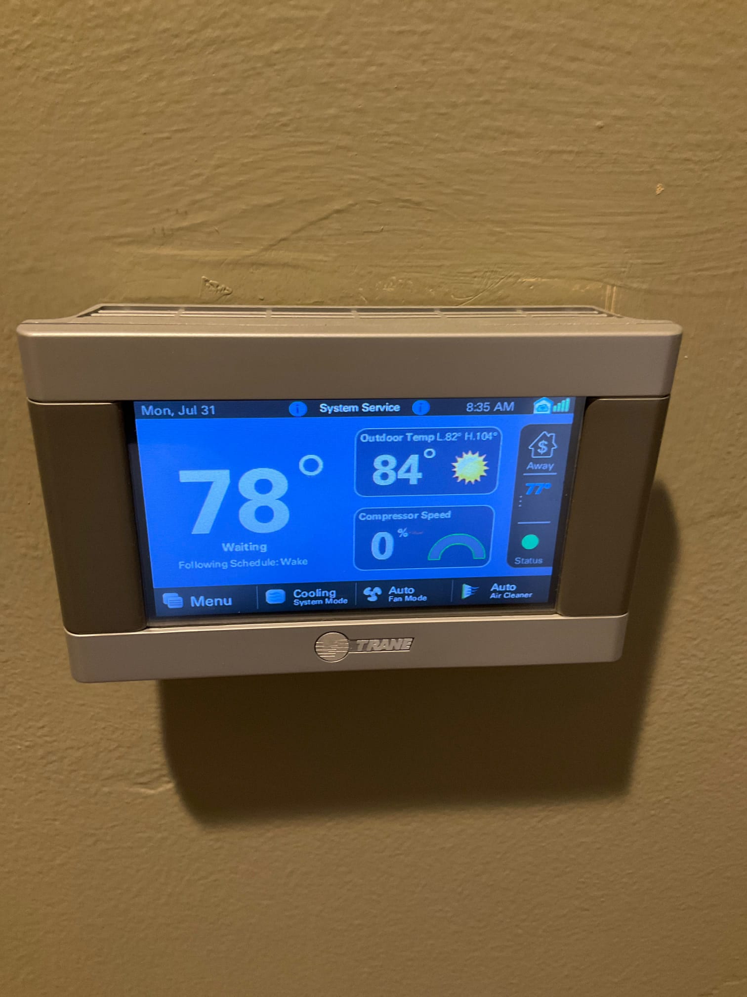 Wall-mounted touchscreen thermostat displays 78° indoor, 84° outdoor, compressor speed 0%, with System Service status.
