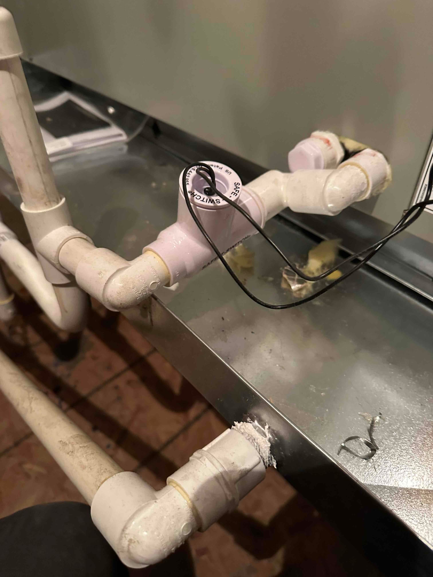 Condensate drainage assembly with a float safety switch wired in on the air handler’s drain line.