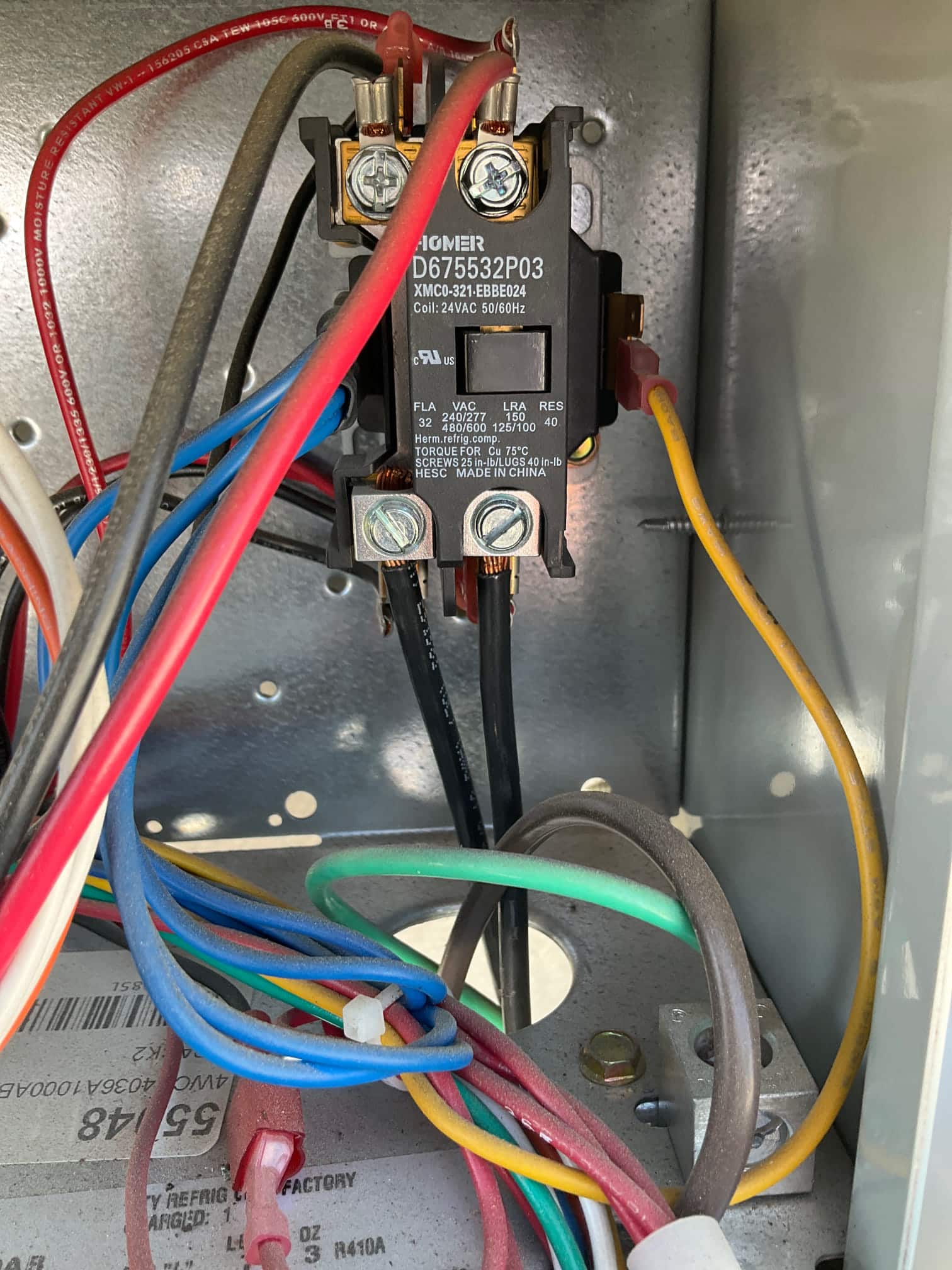 Contactor inside unit cabinet, coil rated 24 VAC 50/60 Hz, with multiple colored wires secured to screw terminals.