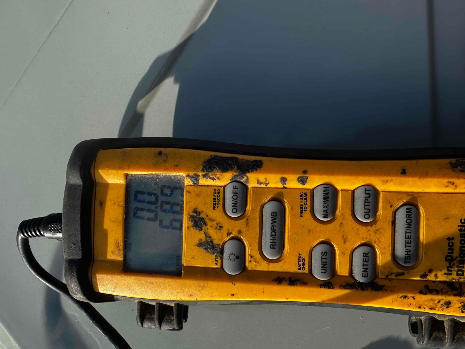 Digital thermometer instrument shows a temperature reading of 68.9 degrees Fahrenheit during air temperature verification on the new system.