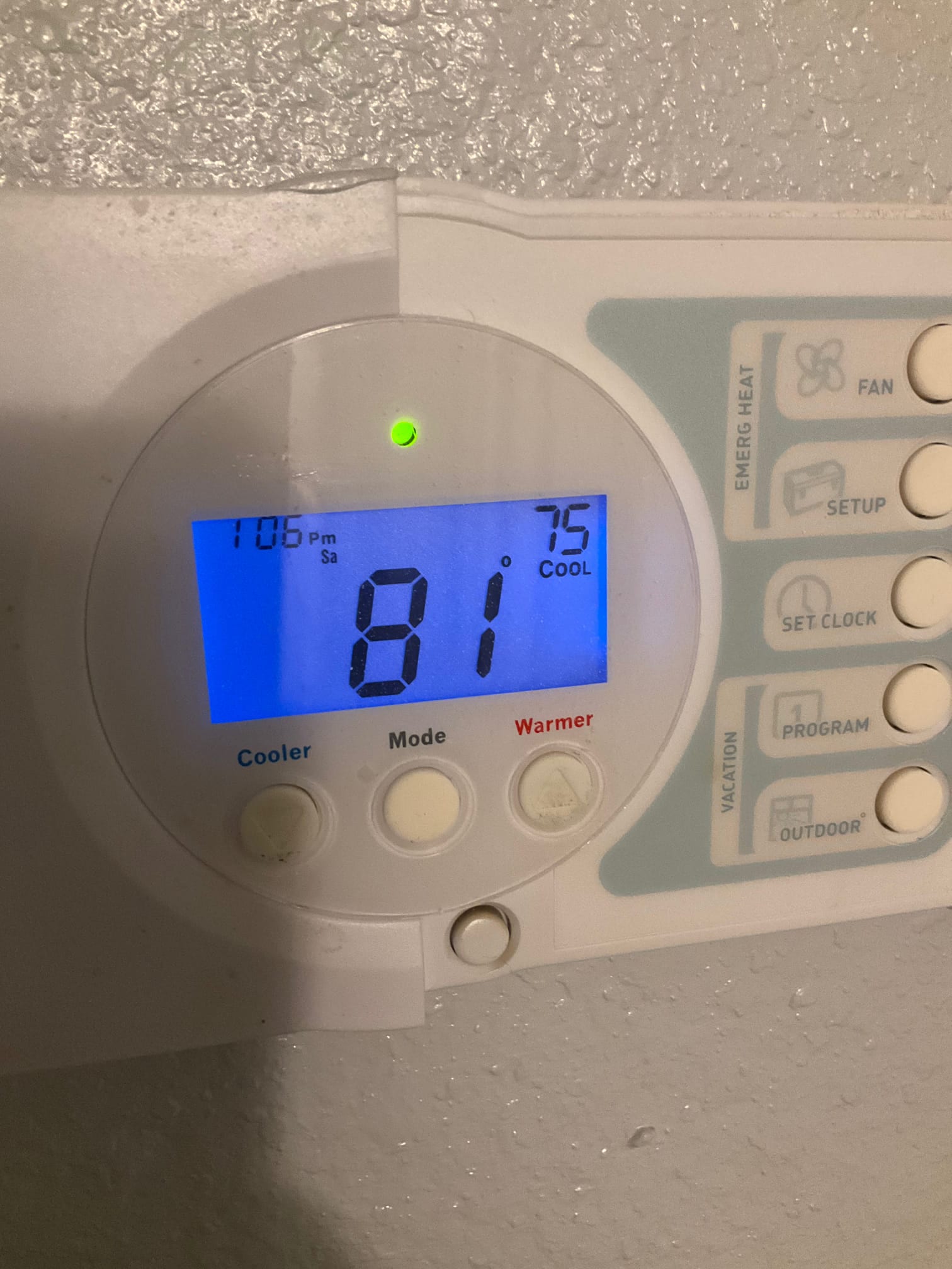 Wall-mounted thermostat display shows 81°F indoors with cooling mode set to 75°F and a green status light.