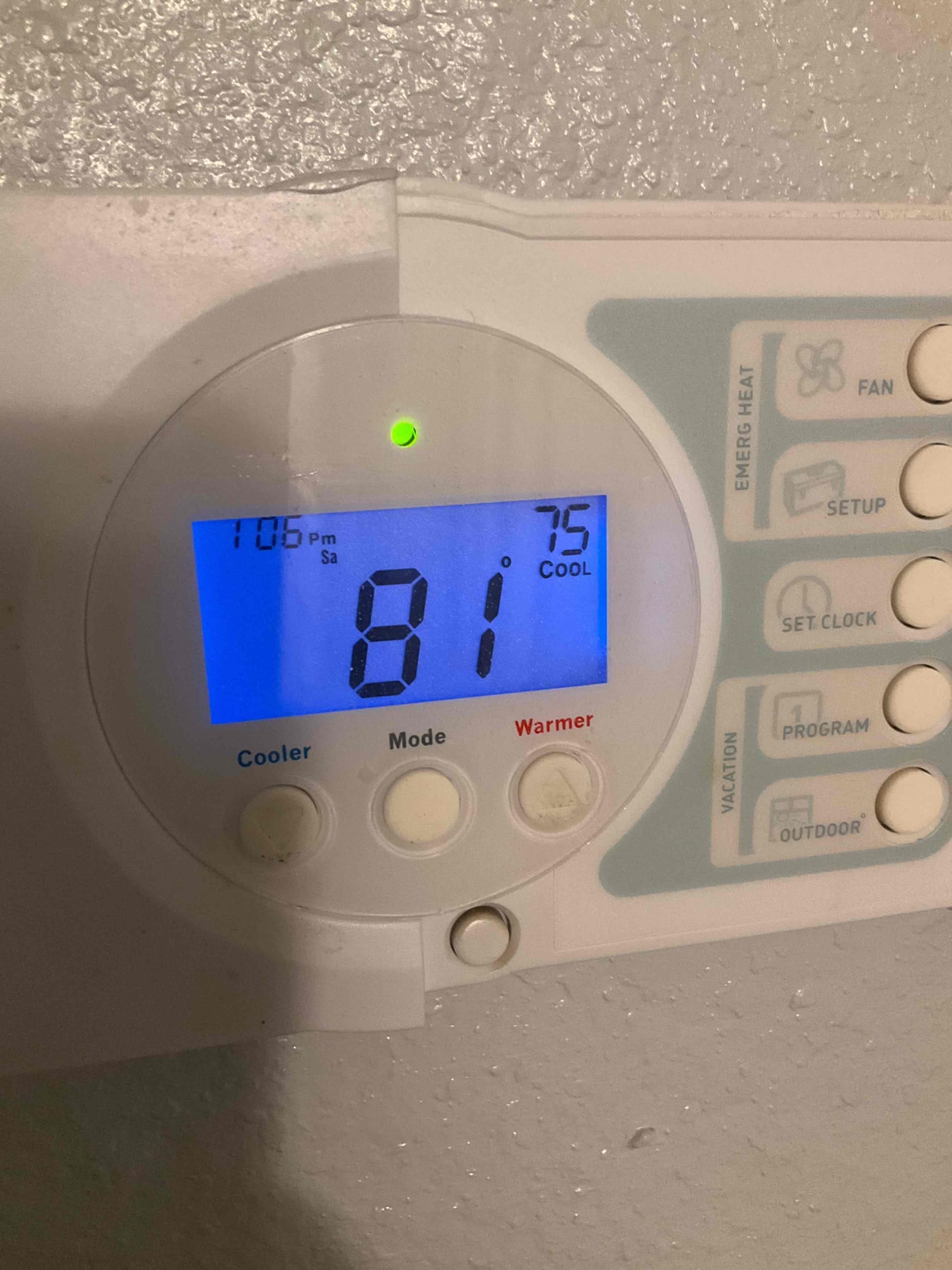 Wall-mounted thermostat displays 81°F room temperature with cooling mode set to 75°F, green indicator illuminated.