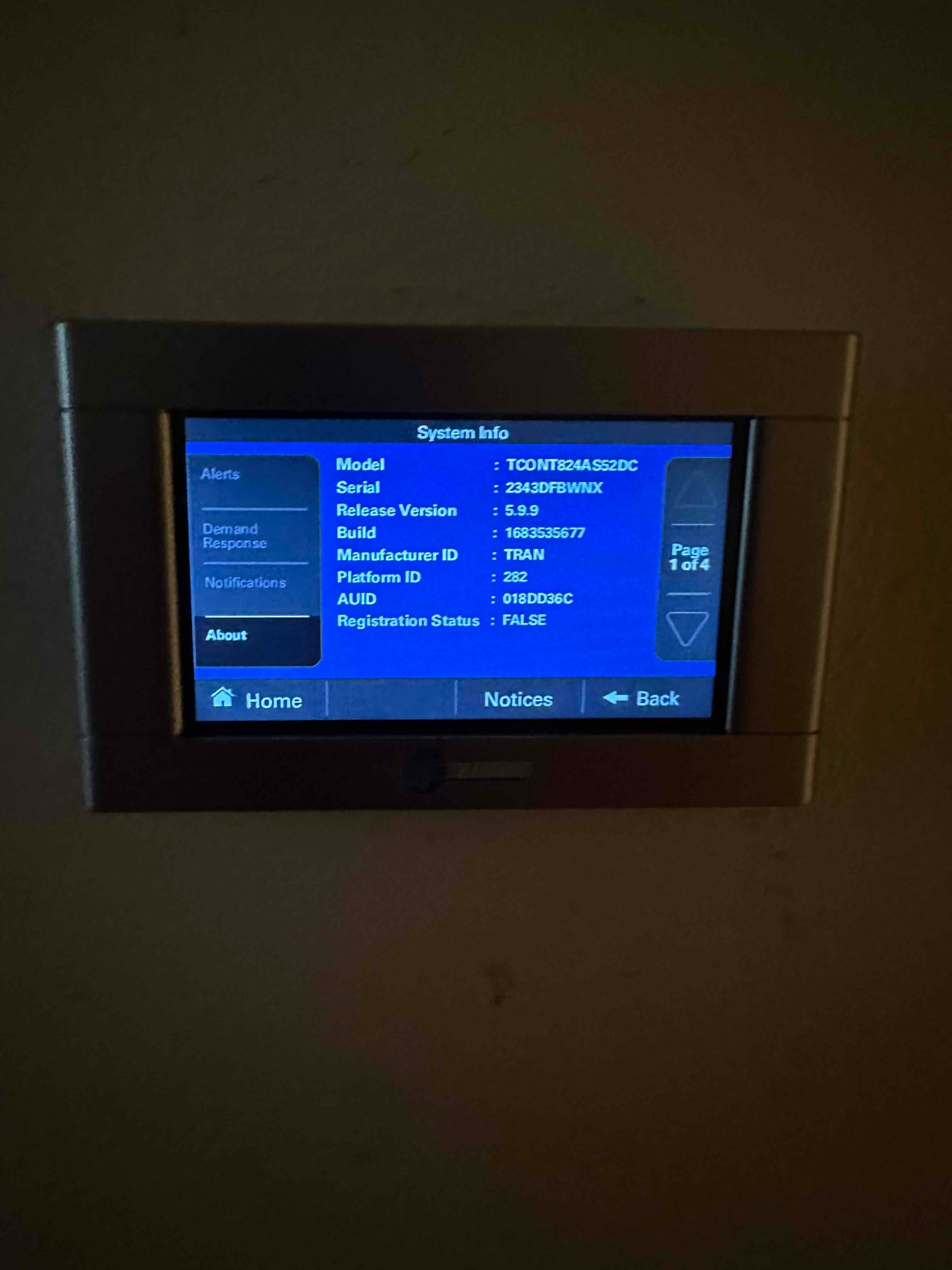 Wall-mounted thermostat touchscreen displays system information menu during setup at the newly installed HVAC system.