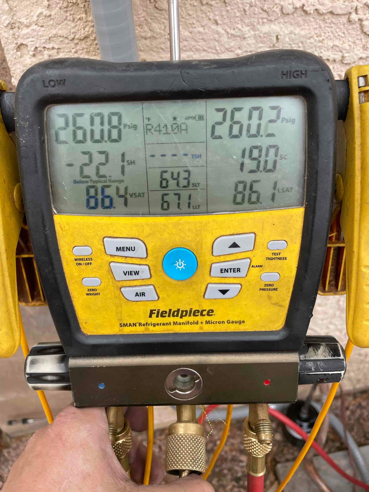 Digital manifold shows both high and low sides holding around 260 PSI, documenting the nitrogen pressure test on the new system.