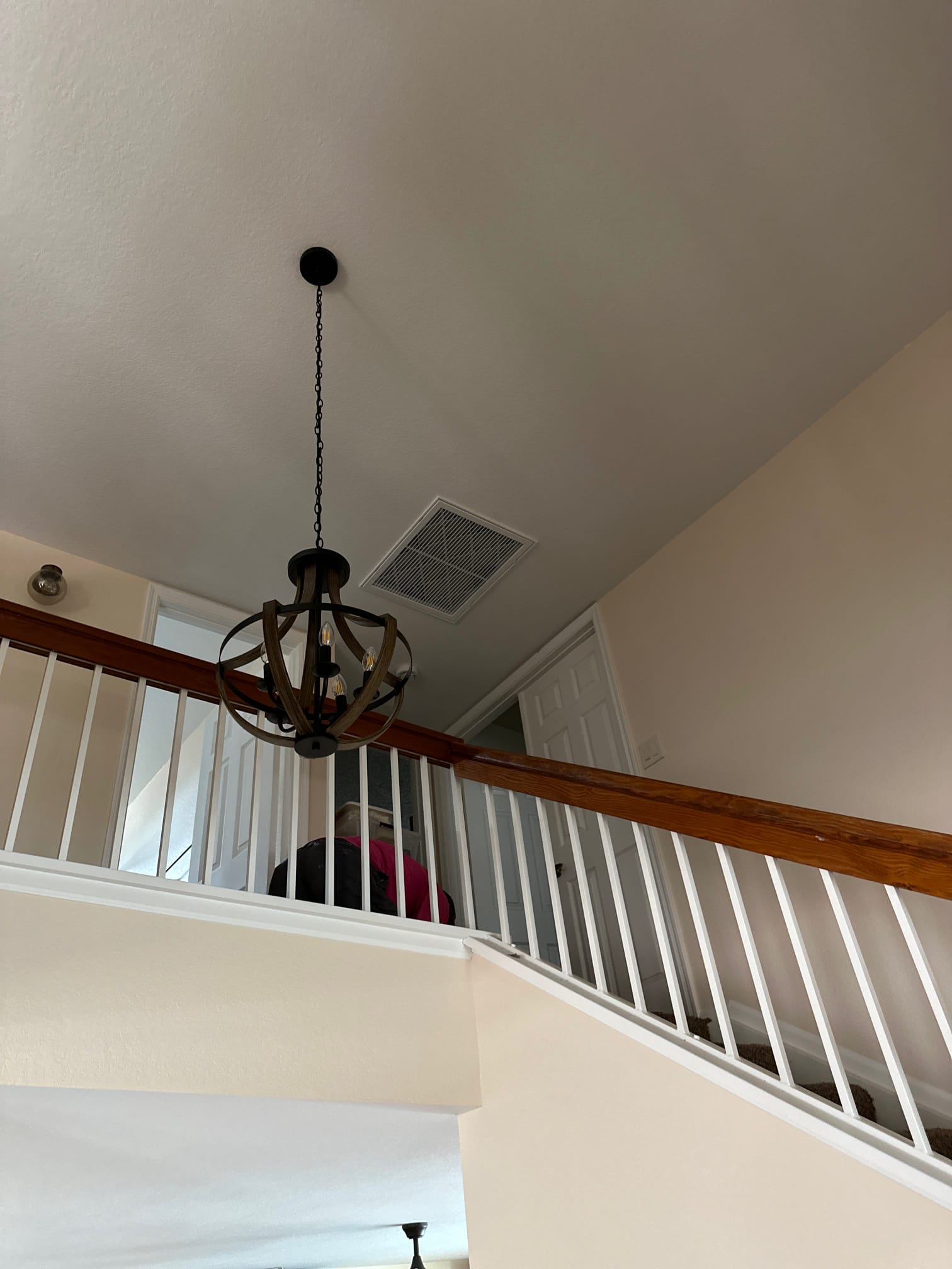 Central return grille at the upstairs landing near the staircase, showing indoor return location and access panel in the hallway.